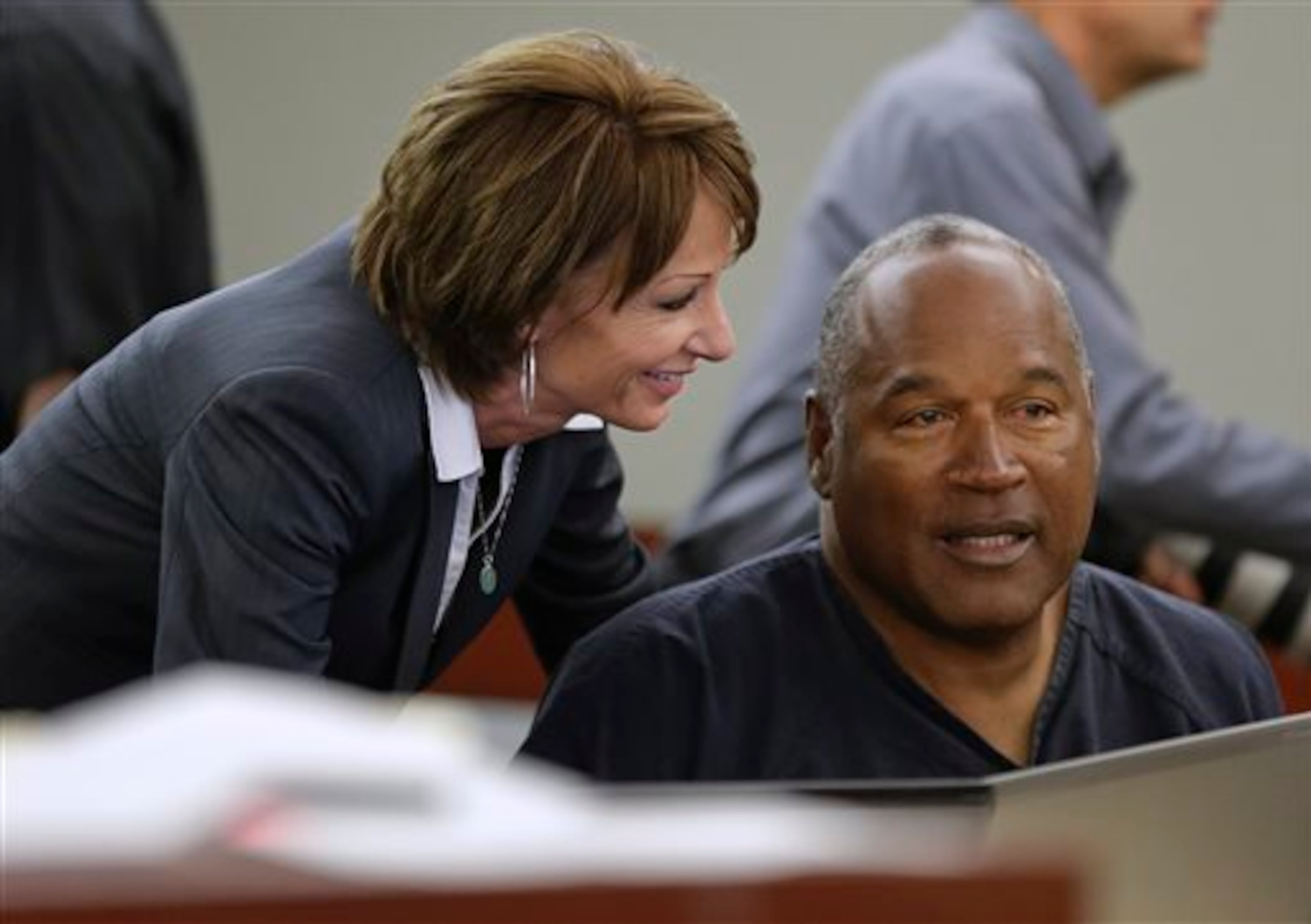 O.J. Simpson, right, talks with his attorney, Patricia Palm in Clark County District Court, Monday, May 13, 2013 in Las Vegas. Simpson, who is currently serving a nine-to-33-year sentence in state prison as a result of his October 2008 conviction on armed robbery and kidnapping charges, is seeking a new trial, claiming that trial lawyer Yale Galanter had conflicted interests and shouldn't have handled Simpson's armed case. (AP Photo/Julie Jacobson, Pool)