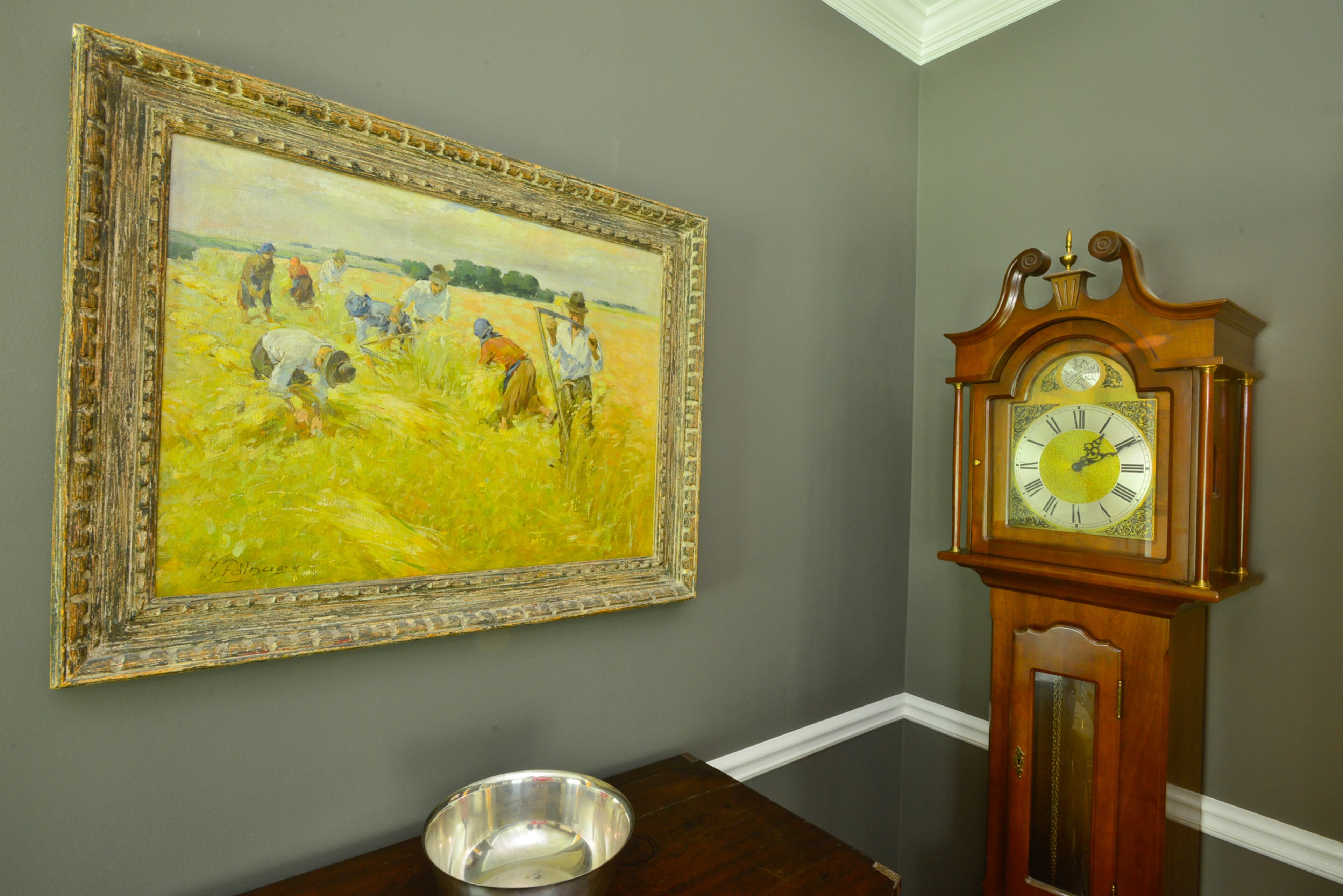 An artist from Hungary, Zsigmond Palnagy, painted the harvest scene in the dining room. The grandfather clock also is a family piece, handed down from homeowner Lisa Gleim-Jonas to her grandfather. Sherwin-Williams' Porpoise was selected for the dining room to bring out the artwork.