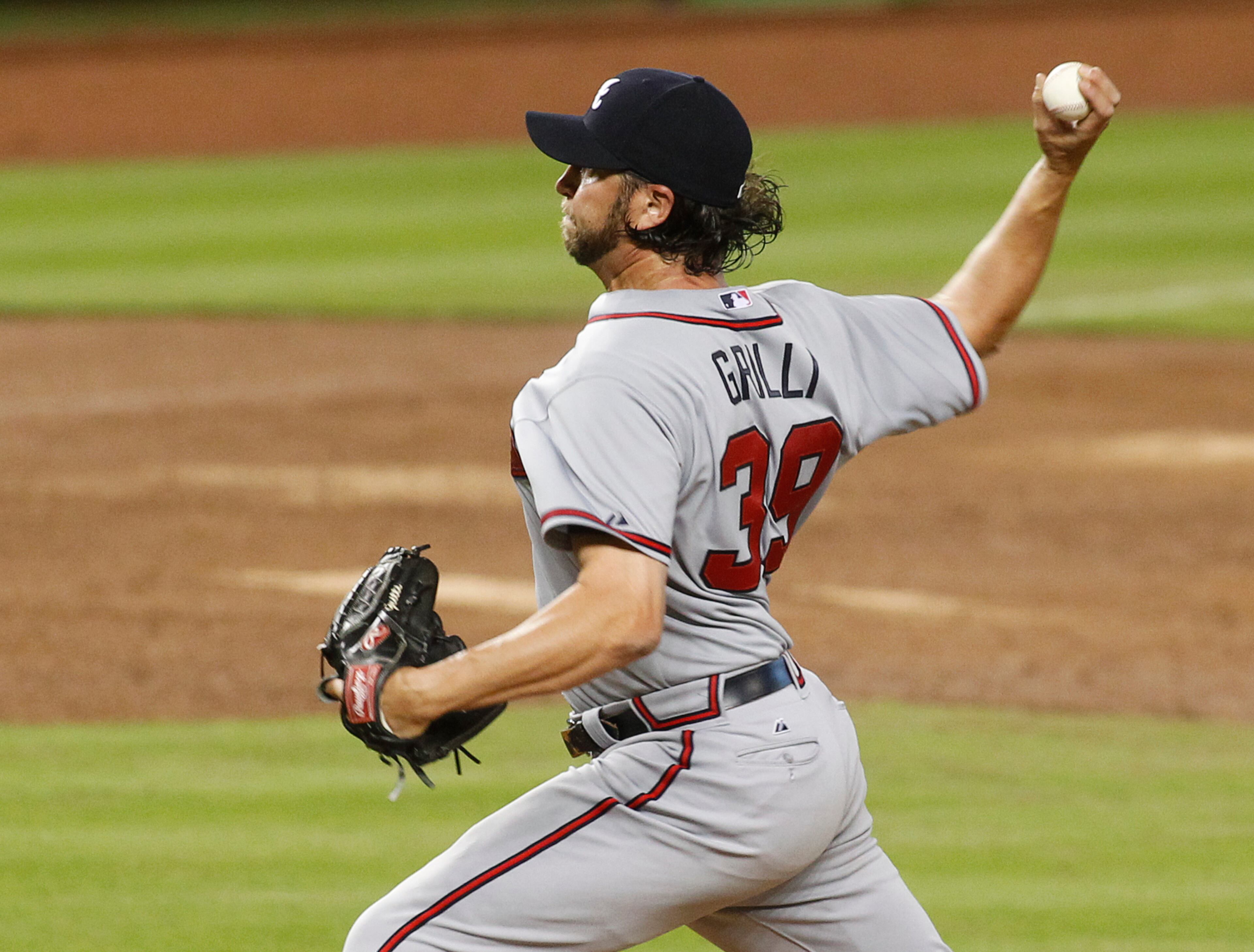 Atlanta Braves relief pitcher Jason Grilli throws against the Miami Marlins in the ninth inning of their opening day baseball game in Miami, Monday, April 6, 2015. The Braves won 2-1. (AP Photo/Joe Skipper)