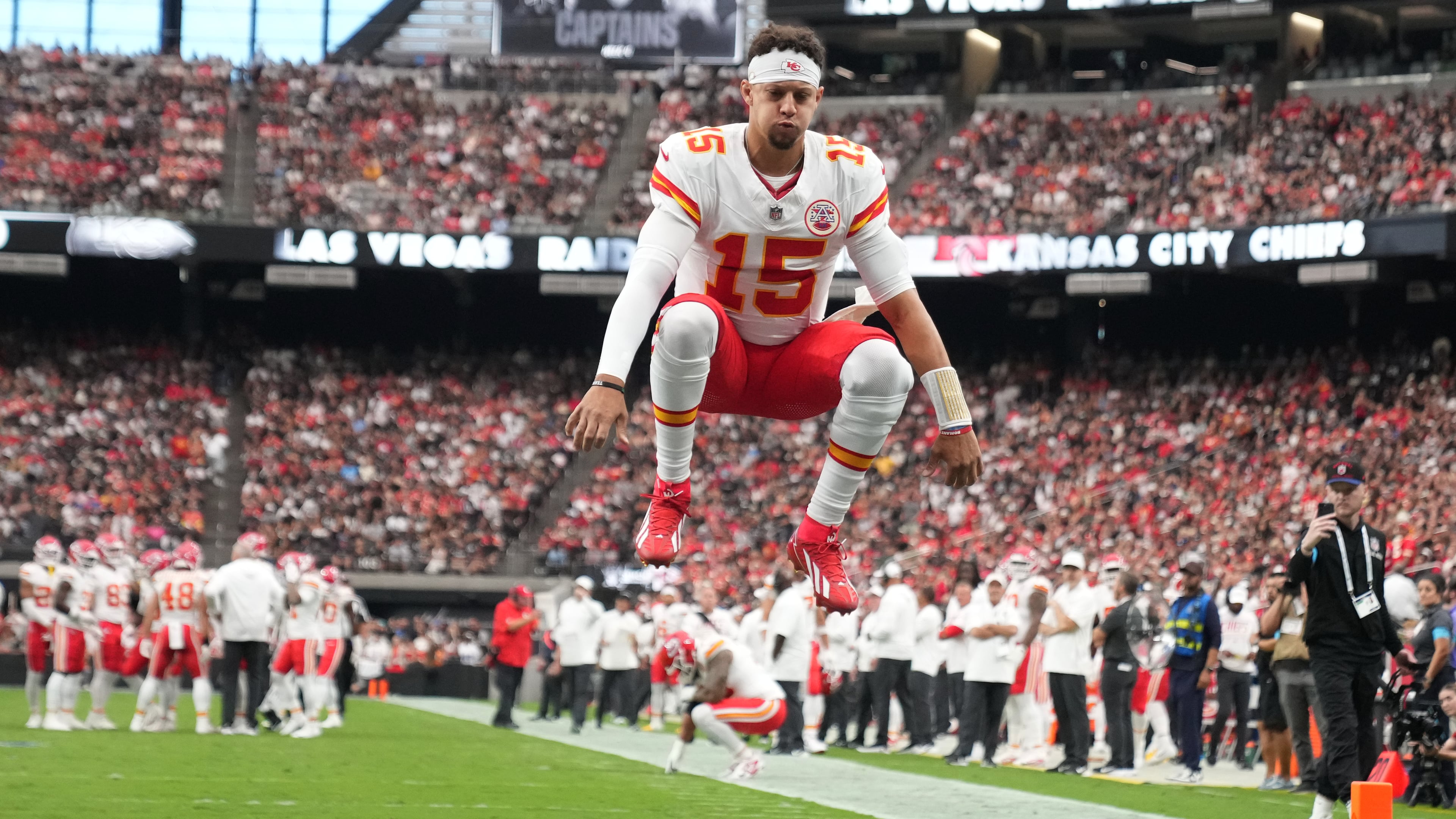 Kansas City Chiefs quarterback Patrick Mahomes (15) jumps into the air before an NFL football game against the Las Vegas Raiders in Las Vegas, Sunday, Oct. 4, 2026. (AP Photo/Rick Scuteri)