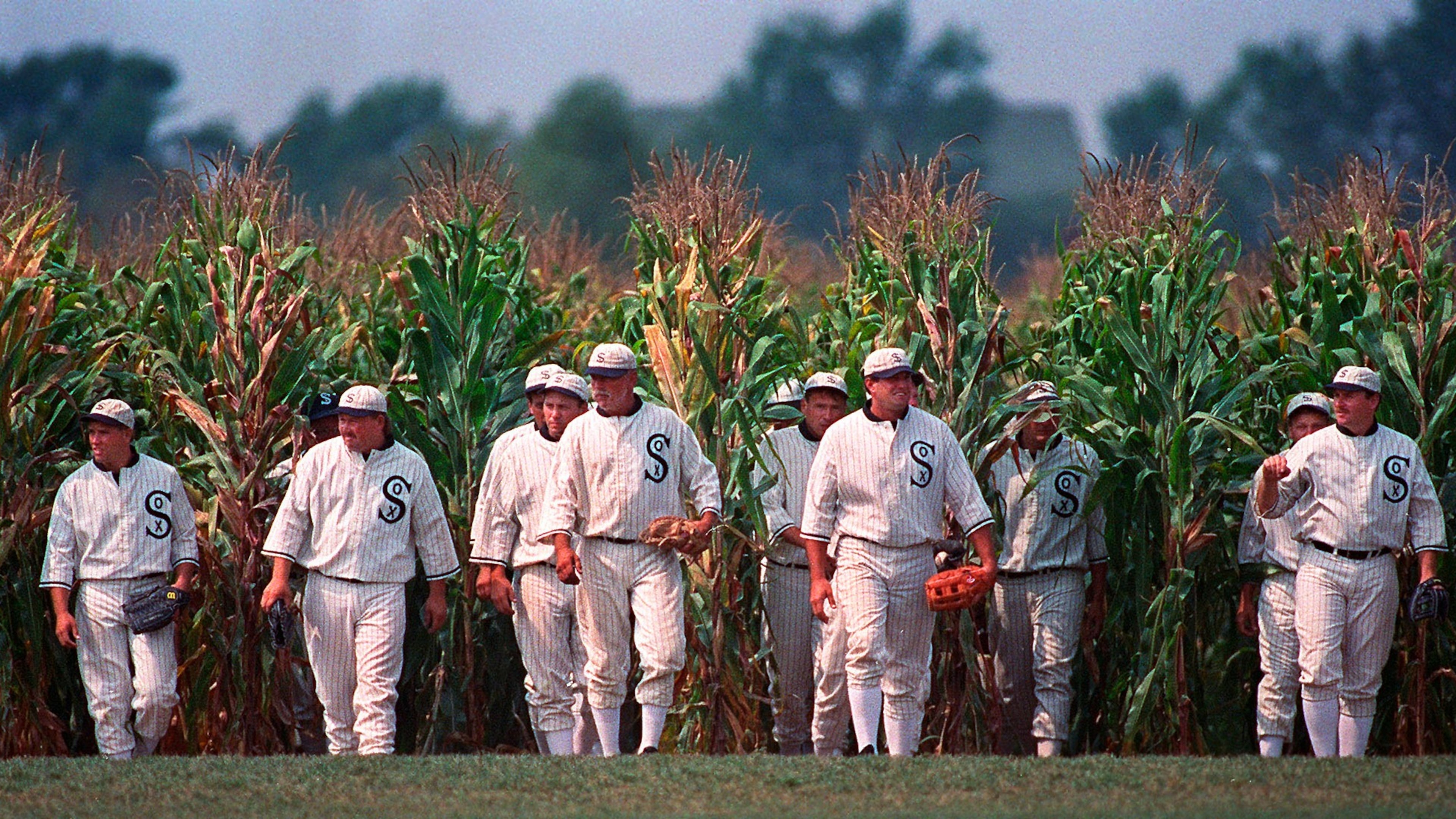 FILE - People portraying ghost players emerge from the cornfield at the "Field of Dreams" movie site in Dyersville, Iowa, on June 22, 1997. (AP Photo/Charlie Neibergall, File)
