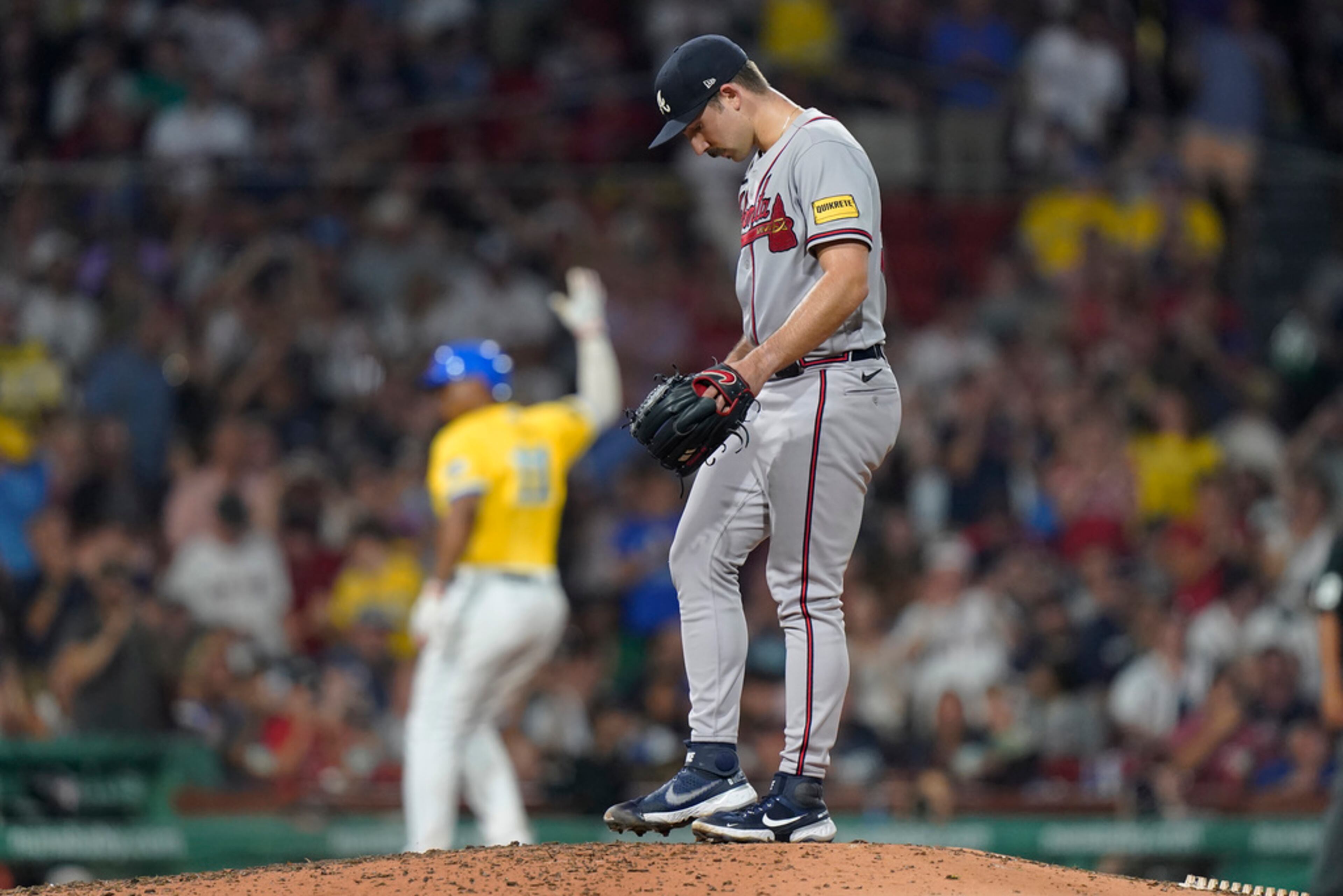 Atlanta Braves' Spencer Strider, right, stands on the mound as Boston Red Sox's Rafael Devers, left, runs toward home after hitting a home run in the sixth inning of a baseball game, Wednesday, July 26, 2023, in Boston. The Braves lost 5-3. (AP Photo/Steven Senne)