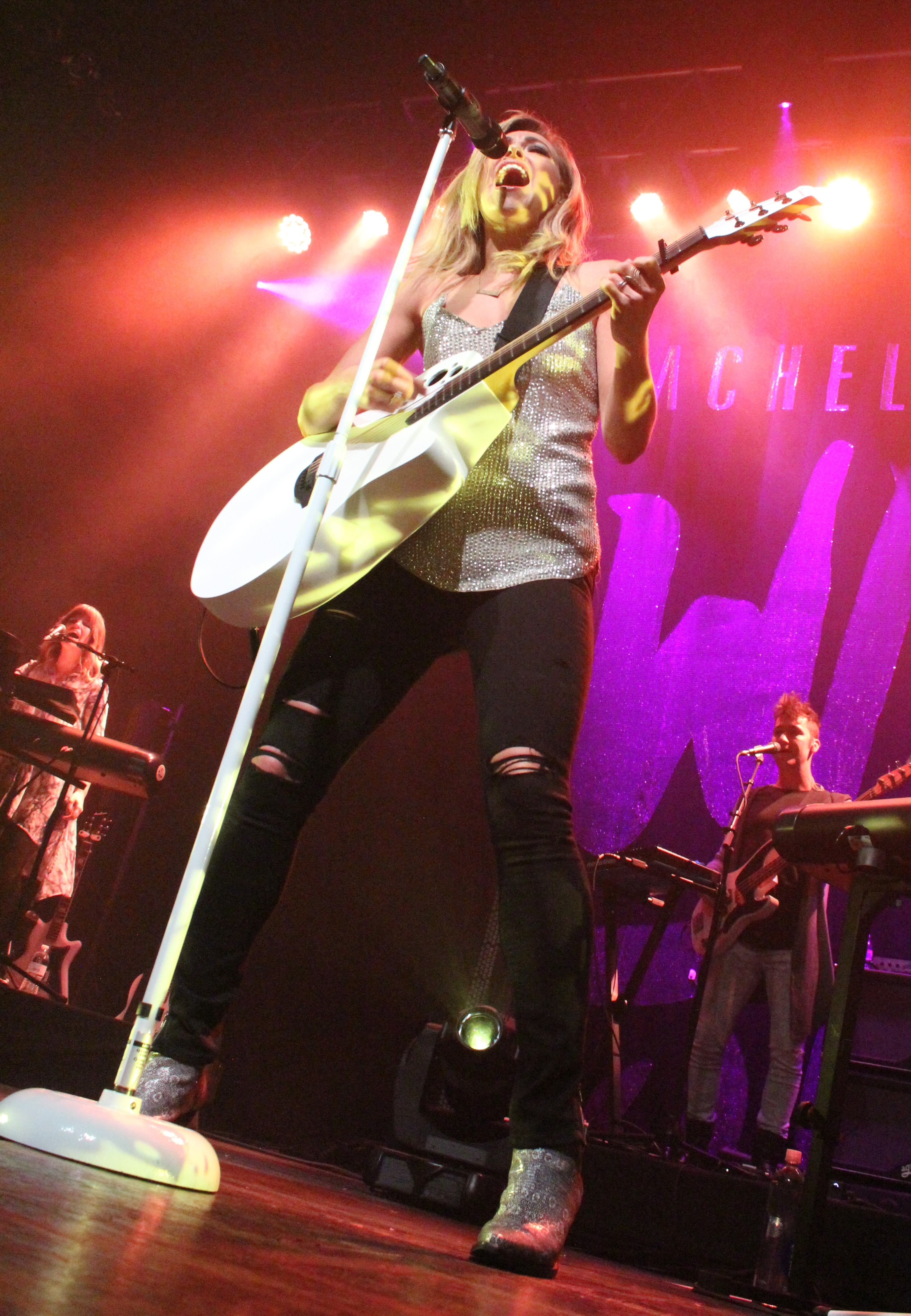 She can rock a guitar AND a mic. Photo: Melissa Ruggieri/AJC