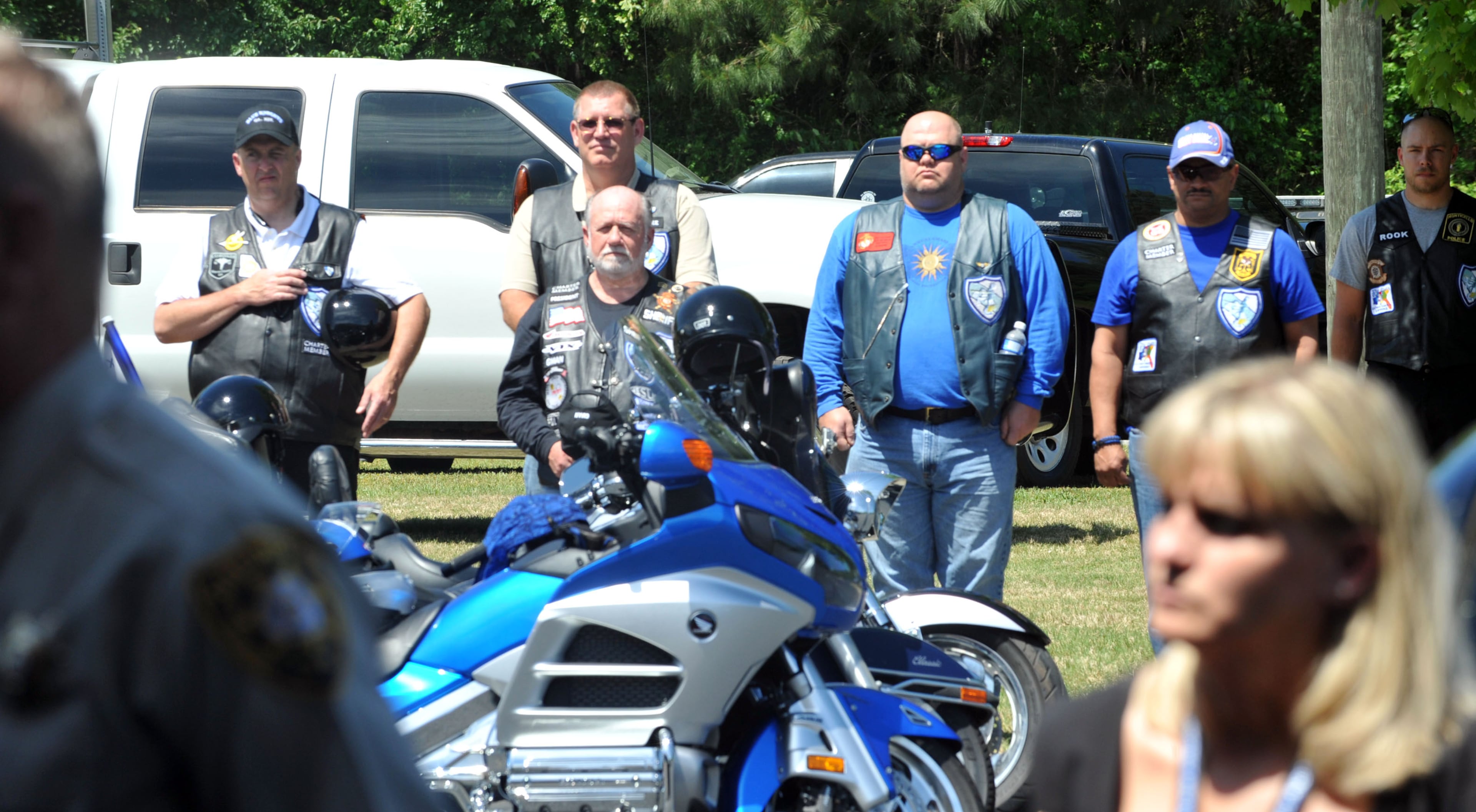 Members of the Blue Knights motorcycle club stand at attention as the casket leaves the chapel.