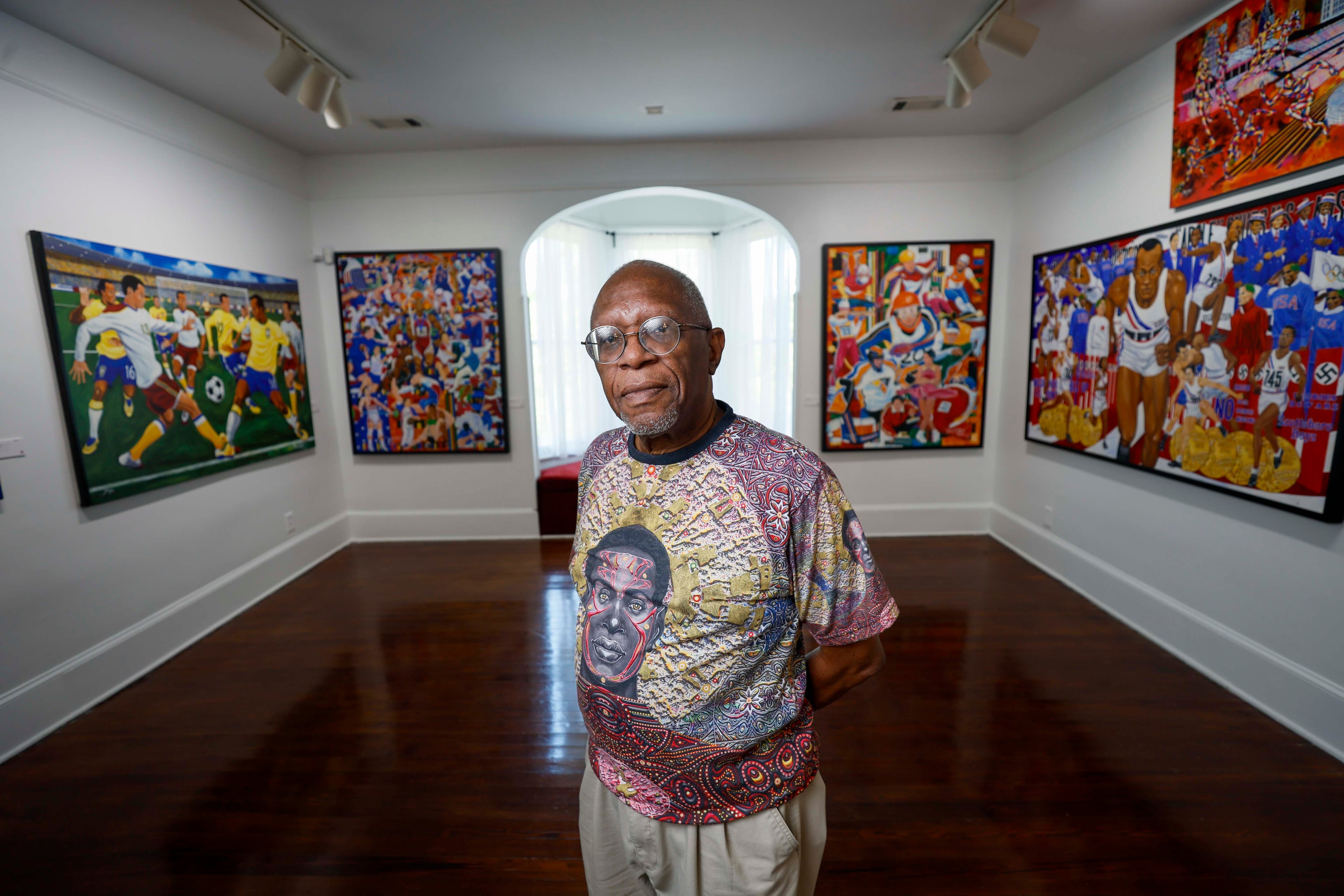 Visual artist Steve Allen poses on the second floor of one of his exhibits at the Hammonds House Museum on Thursday, August 20, 2026. Allen’s exhibit comprises two parts. Downstairs is “Infinite Inheritance,” and upstairs is “O Jogo Bonito (The Beautiful Game).” The downstairs section explores Black ancestry, while the upstairs exhibition features works inspired by the Olympic Games. (Miguel Martinez/AJC)