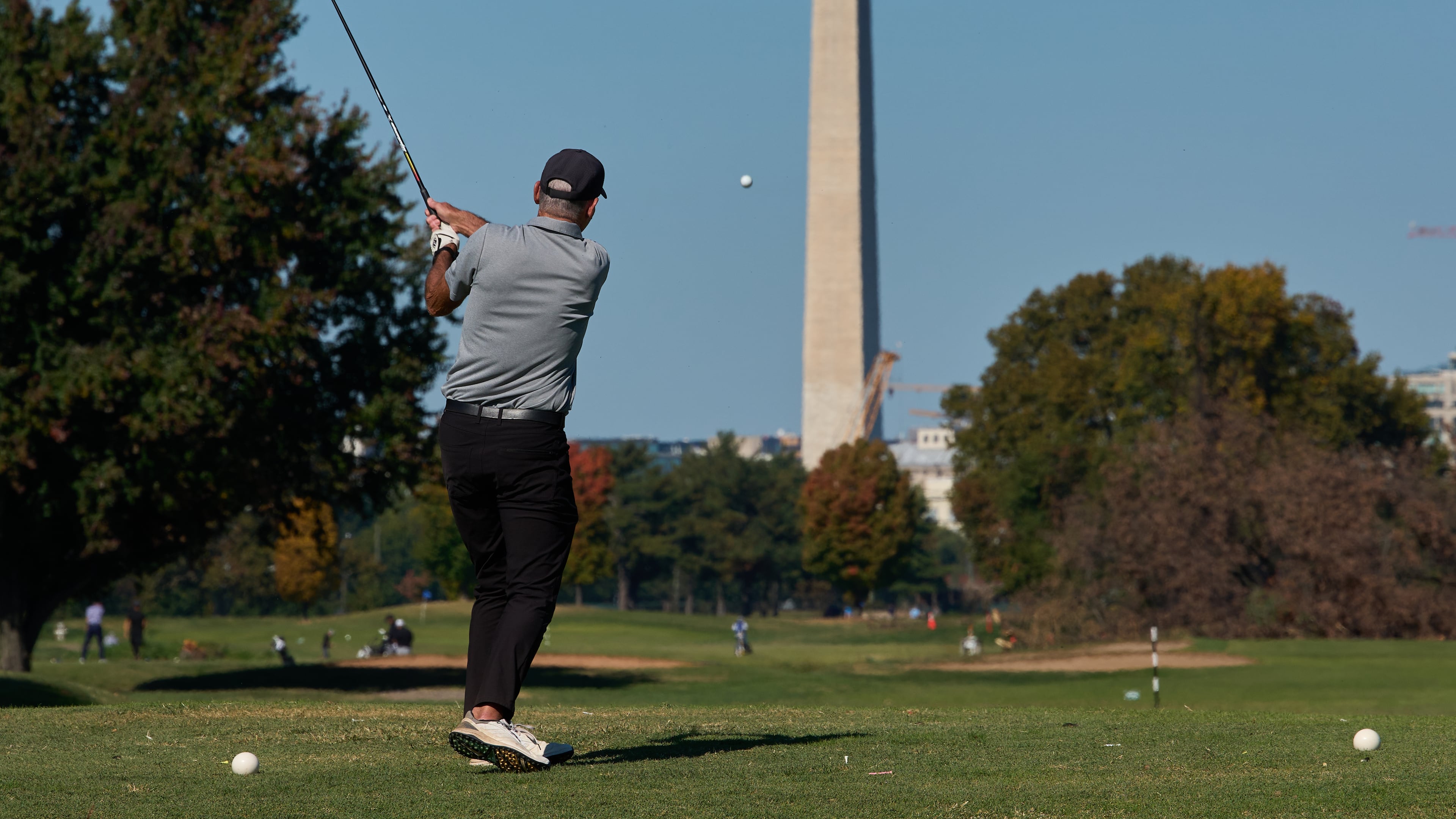 The Washington Monument is seen as a golfer takes a swing at East Potomac Park Golf Course, Monday, Oct. 26, 2026, in Washington. (AP Photo/Julia Demaree Nikhinson)