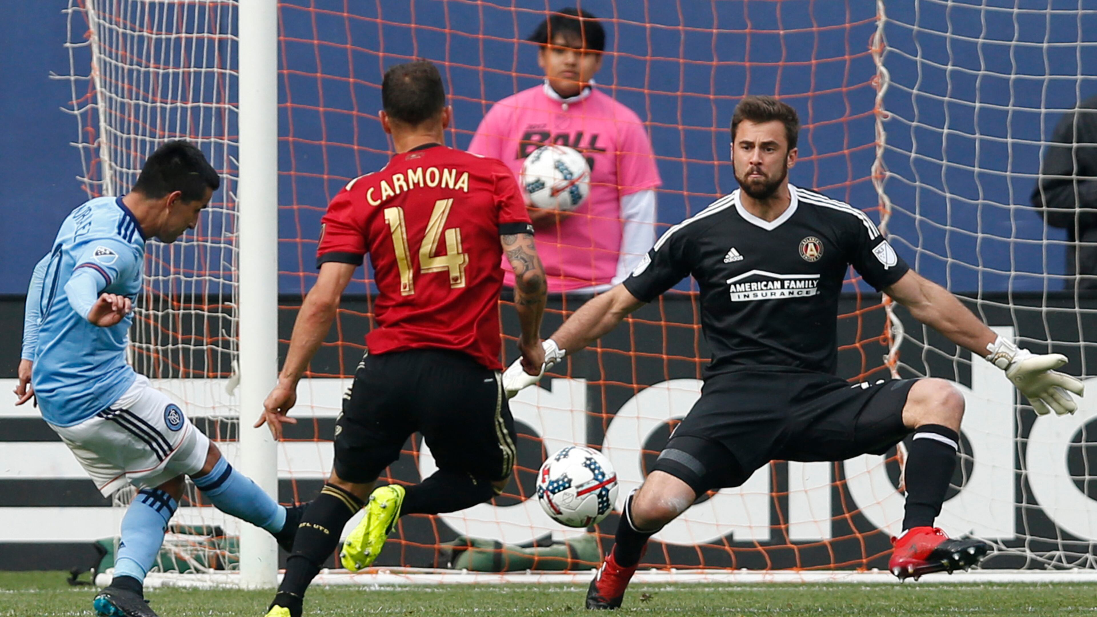 New York City FC midfielder Maximiliano Moralez (10), of Argentina, kicks a goal with Atlanta United midfielder Carlos Carmona (14) defending that Atlanta United goalkeeper Alec Kann (25) failed to stop during the second half of an MLS soccer game, Sunday, May 7, 2017, in New York. New York City FC defeated Atlanta United 3-1. (AP Photo/Kathy Willens)