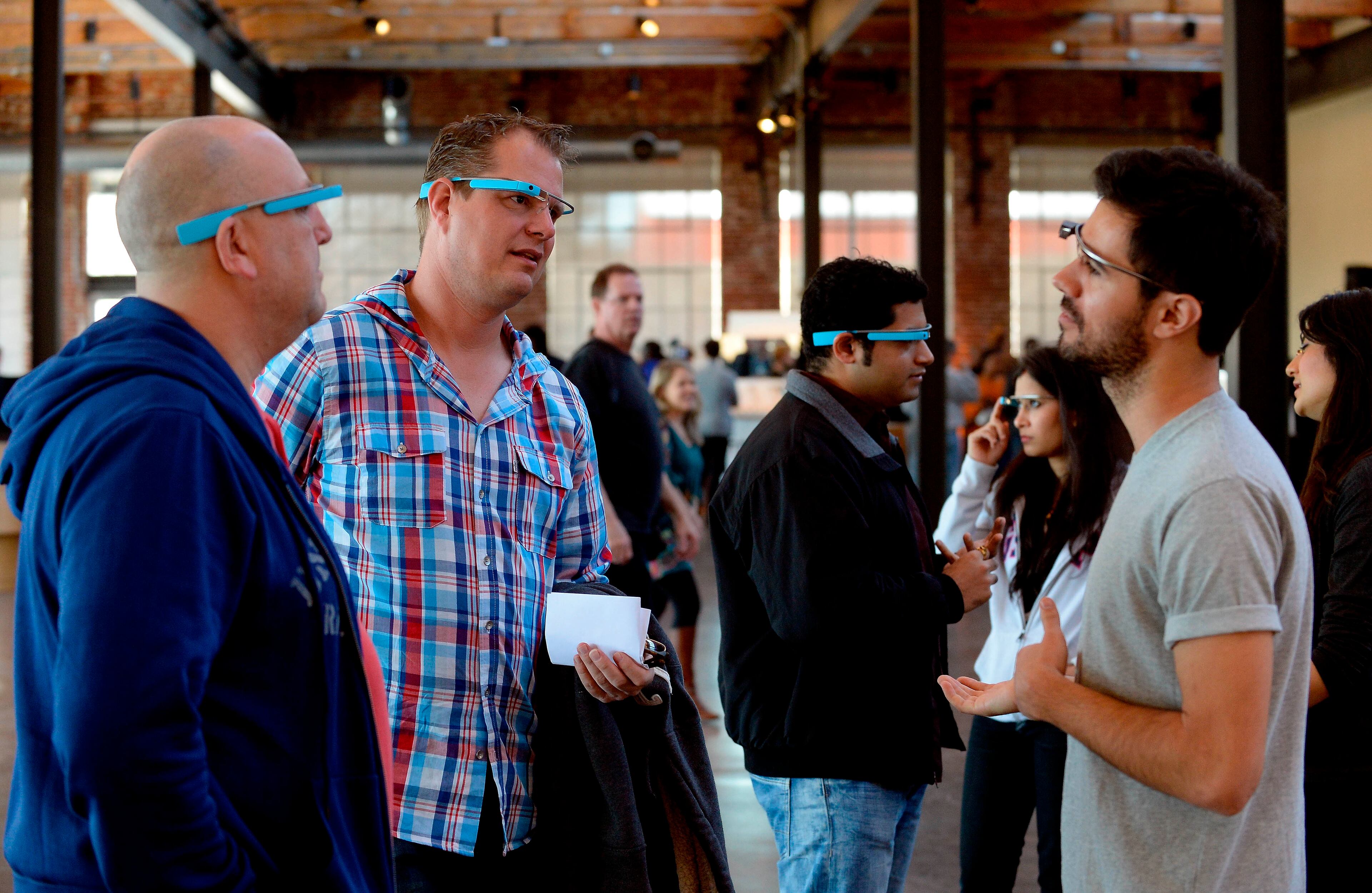 Kees Morsman, left, and Hans Schepers, both from the Netherlands, get some operating tips from Google Glass's Holland Rocha, right, during a stop at Puritan Mill that allowed potential early adopters a chance to experience the wearable computer on Saturday, Feb. 8, 2014, in Atlanta. Morsman and Schepers experienced a brief introduction to the device while more than 100 early adopters from Georgia are already participating in the everyday Glass Explorers testing program that was introduced last year. David Tulis / AJC Special