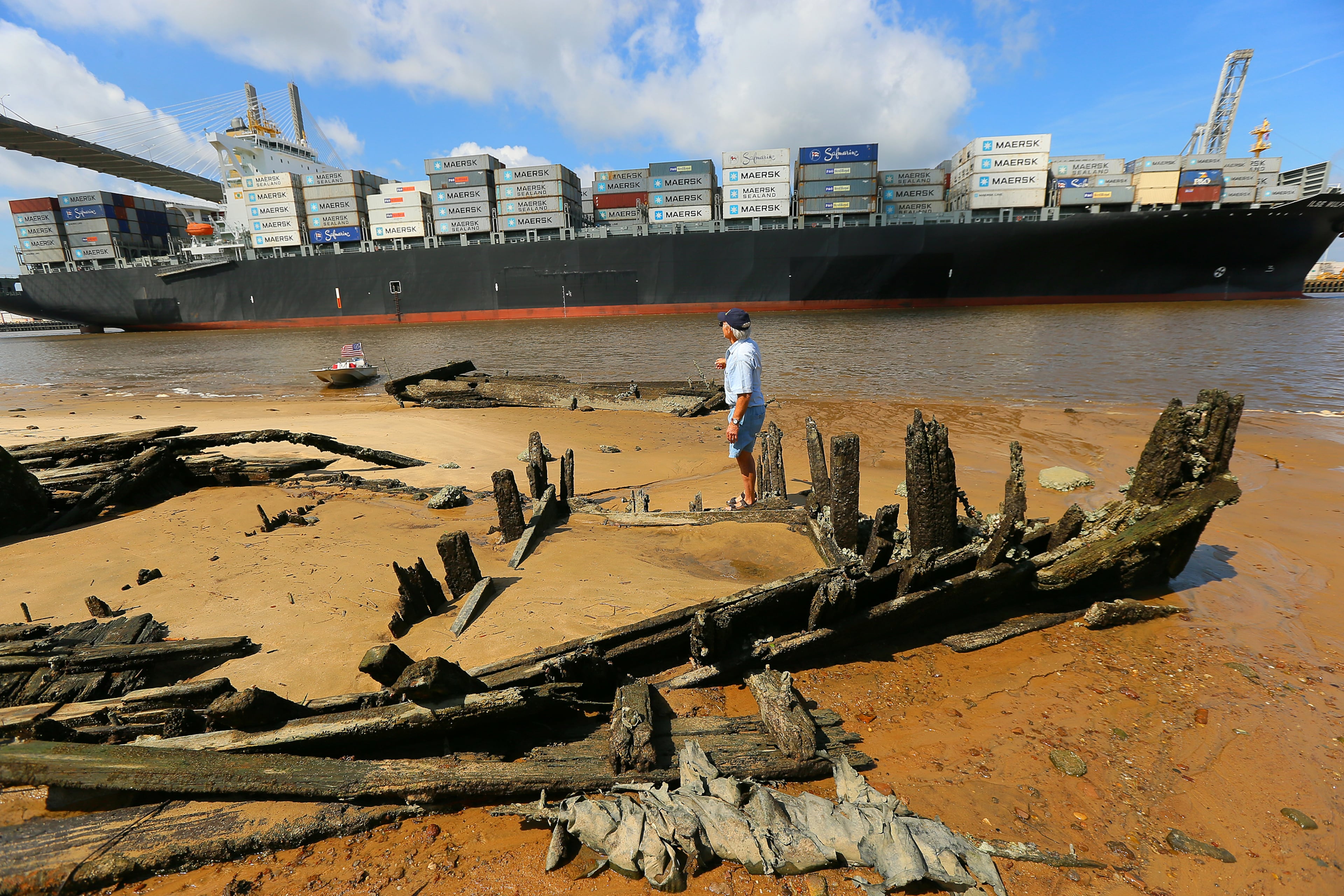 Charlie Ellis pauses to take in a passing ship headed into port while searching for artifacts around the shipwreck called "Dave's Derelict. "I never get tired of watching those ships go by," Ellis said. As a hobby, Ellis, now in his 70s, has been searching the historically rich area rivers for items that interest him since the age of 12.