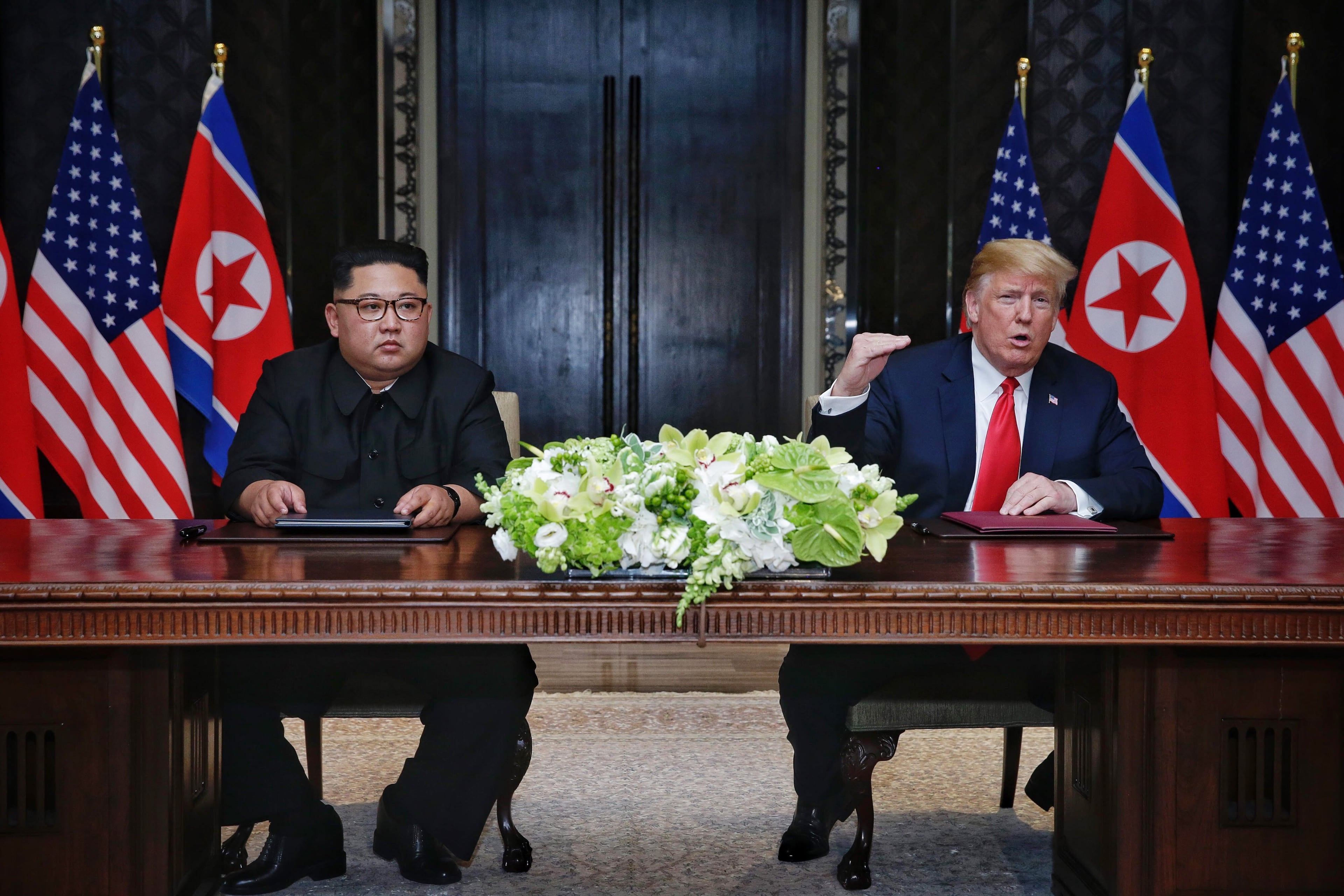 SINGAPORE, SINGAPORE - JUNE 12: In this handout photograph provided by The Strait Times, North Korean leader Kim Jong-un (L) with U.S. President Donald Trump (R) during their historic U.S.-DPRK summit at the Capella Hotel on Sentosa island on June 12, 2018 in Singapore. U.S. President Trump and North Korean leader Kim Jong-un held the historic meeting between leaders of both countries on Tuesday morning in Singapore, carrying hopes to end decades of hostility and the threat of North Korea's nuclear programme. (Photo by Kevin Lim/The Strait Times/Handout/Getty Images)