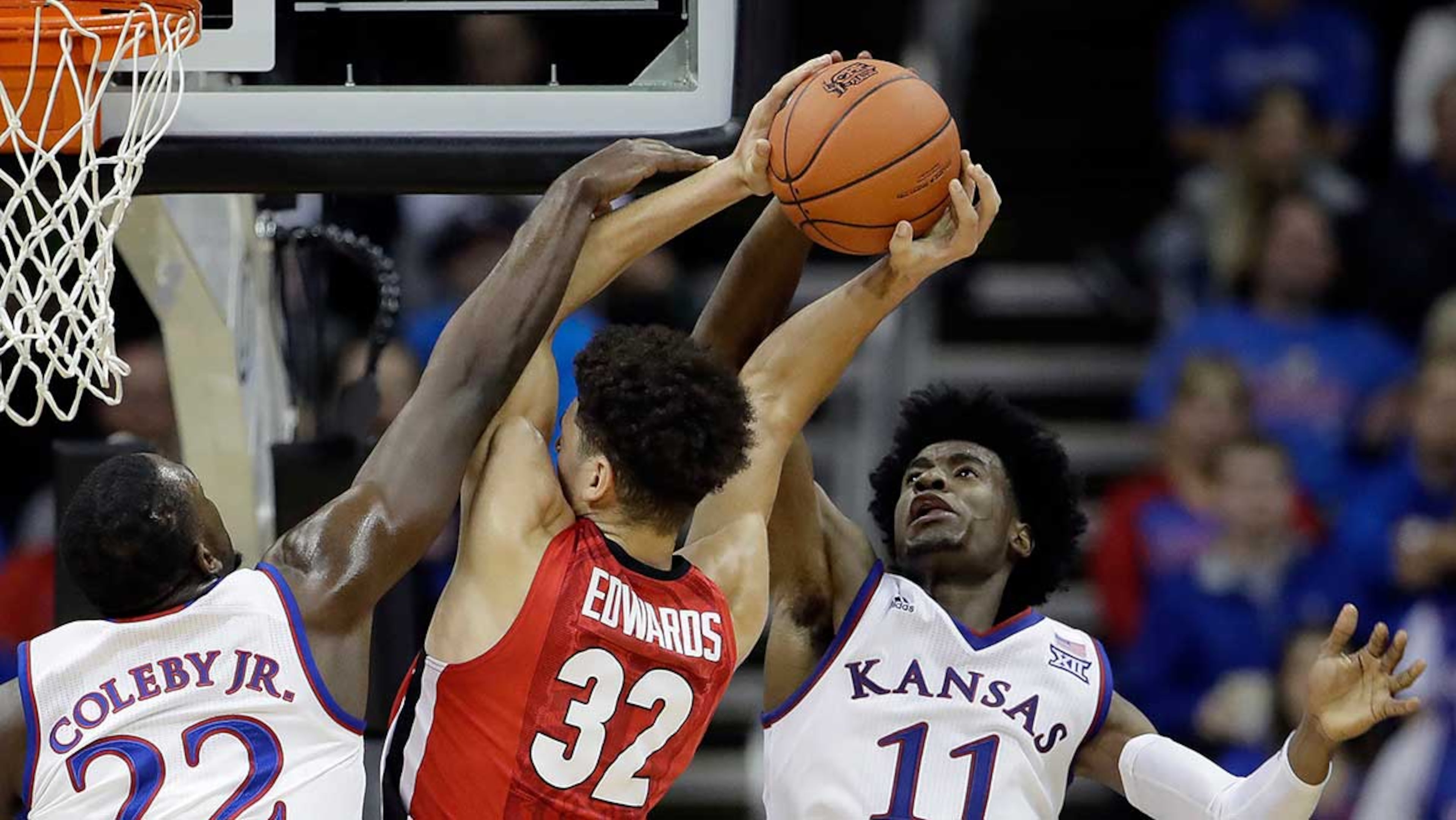 Kansas' Dwight Coleby and Josh Jackson apply pressure to a shot attempt by Georgia's Mike Edwards.
