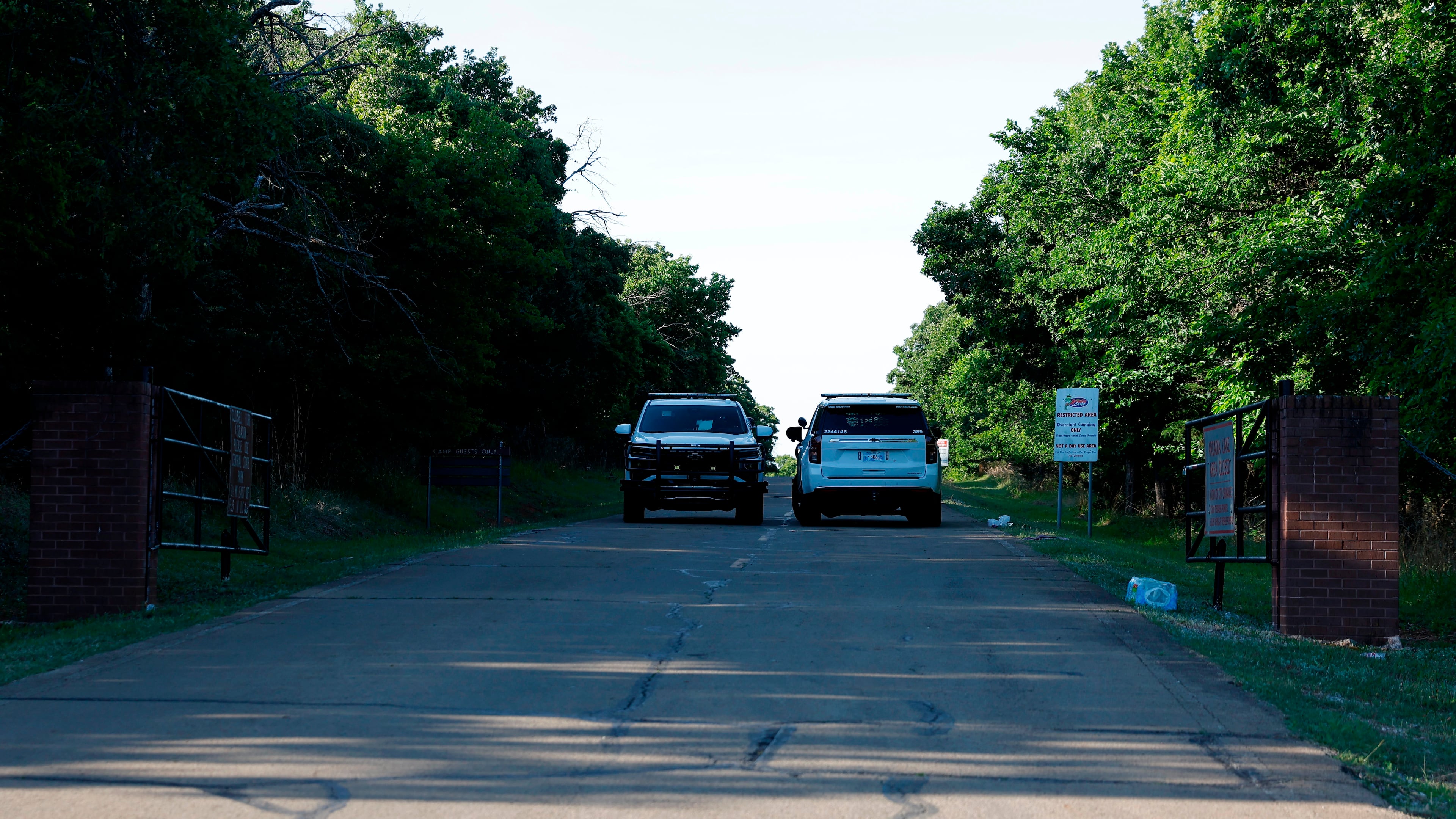 Officials block the entrance to Scissortail Campground at Arcadia Lake, Monday, May 4, 2026, in Edmond, Okla., after a shooting Sunday evening. (AP Photo/Alonzo Adams)
