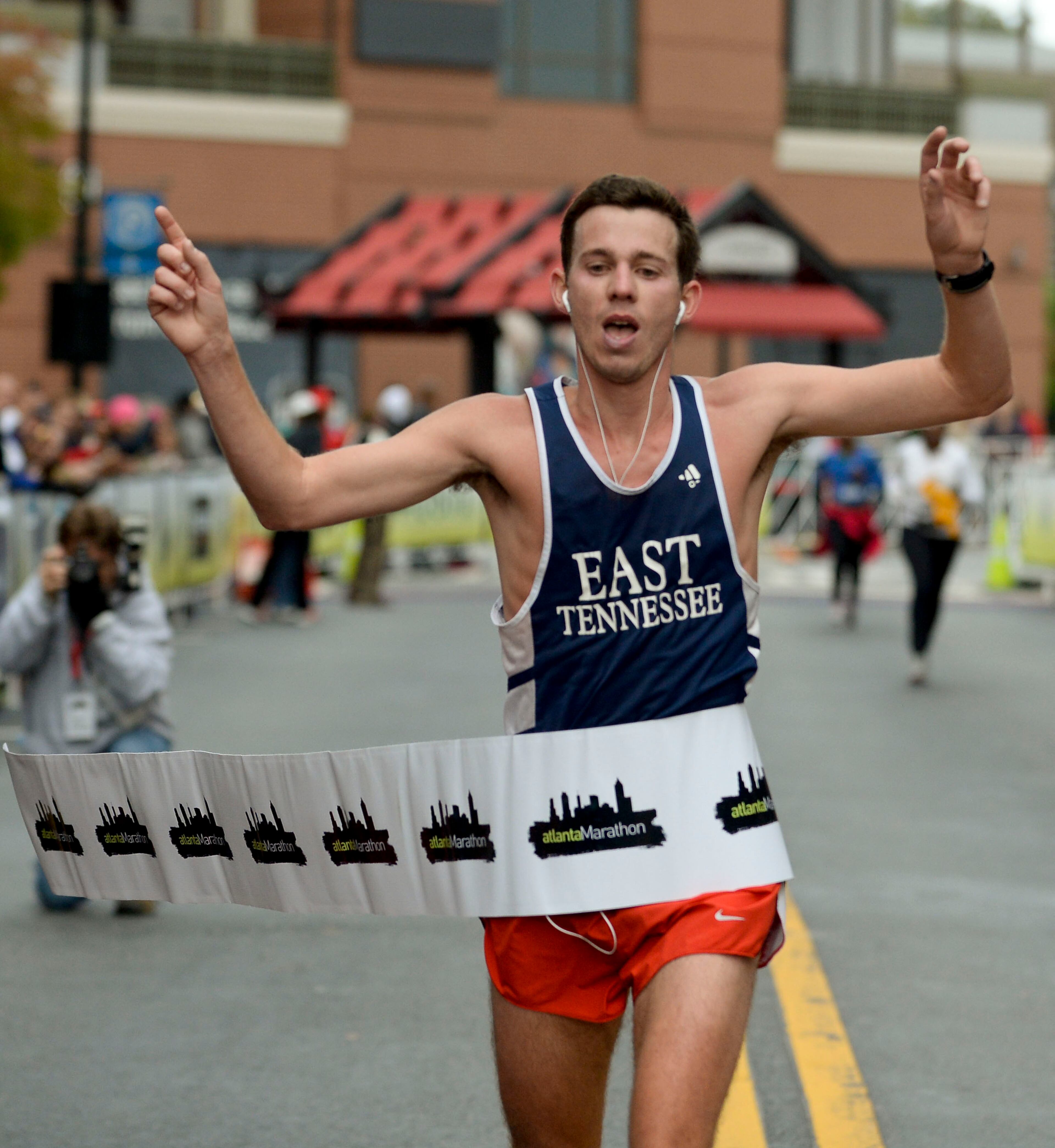 Atlanta Marathon men's winner J. Penny crosses the Atlantic Station finish line of the 26-mile event with an unofficial time of 2:39:04 on Sunday, Oct. 27, 2013, in Atlanta. David Tulis / AJC Special