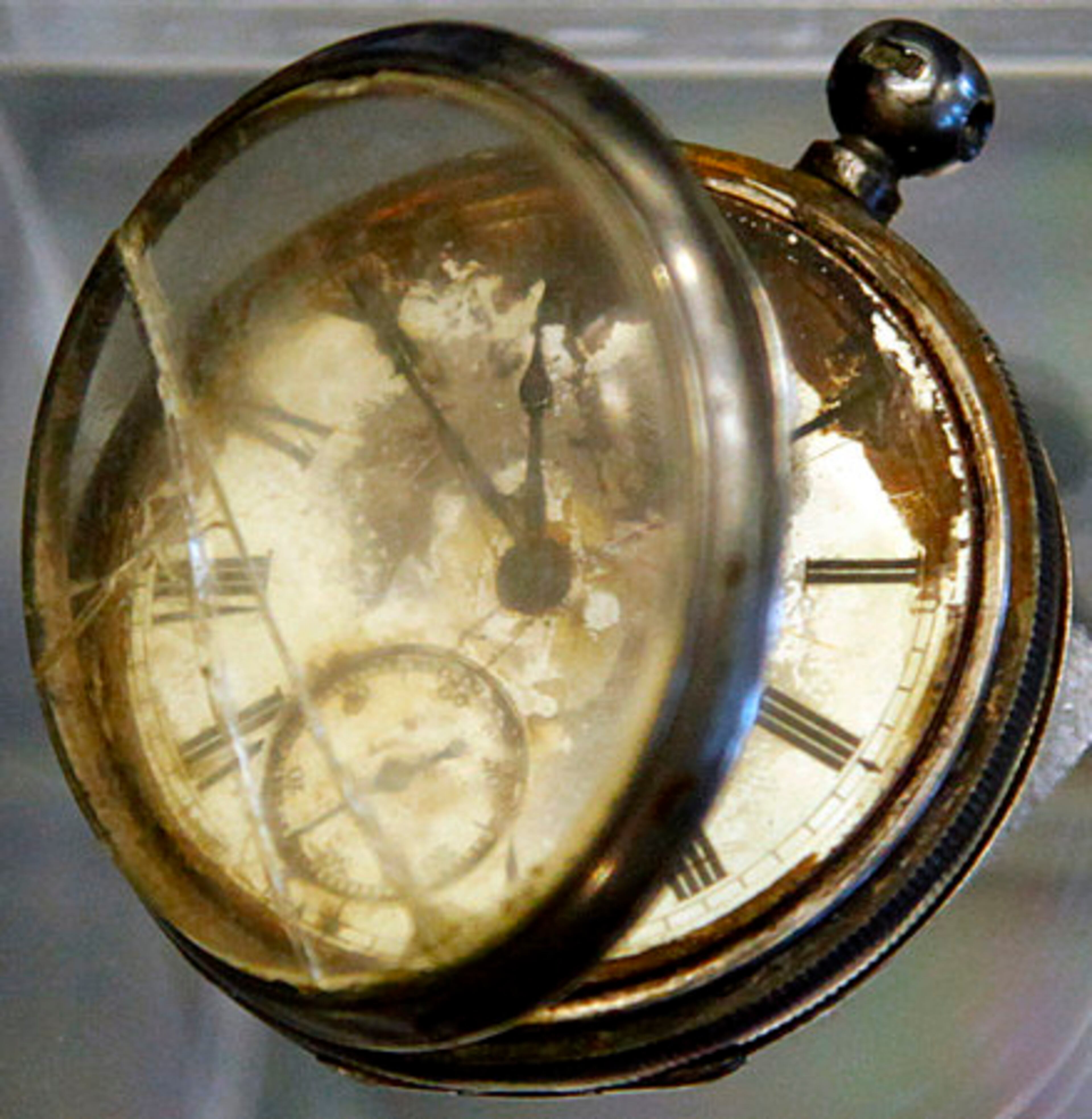 FILE - This file photo shows a pocket watch found in the belongings of a third class passenger named William Henry Allen, found in the Titanic wreckage, among a sampling of Titanic artifacts on preview for auction in New York.