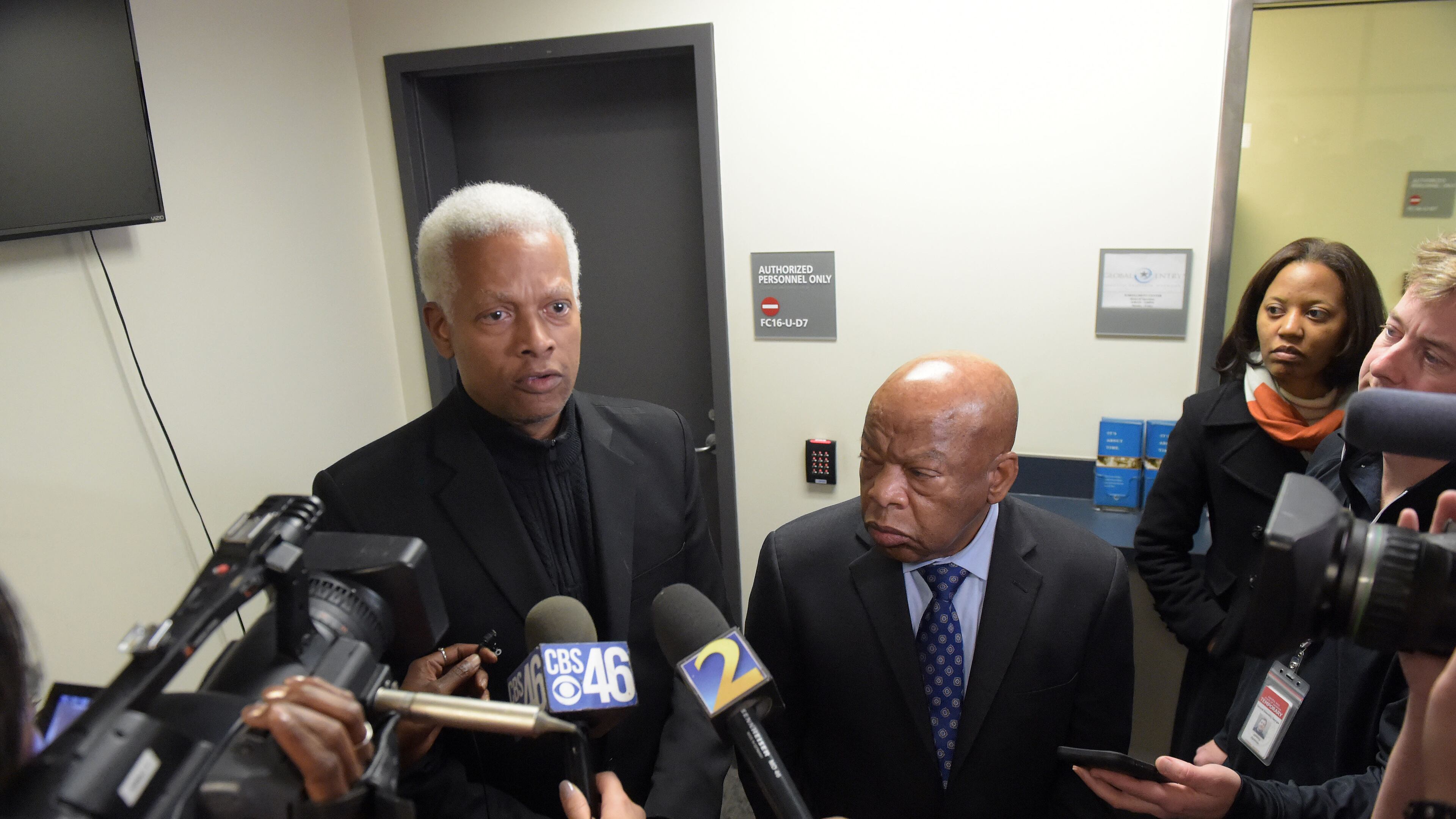 Democratic U. S. Congressmen Hank Johnson, left, and John Lewis talk with the media following a meeting inside the Customs and Border Protection office at Hartsfield Jackson International airport on Jan. 25, 2017. Kent D. Johnson/AJC