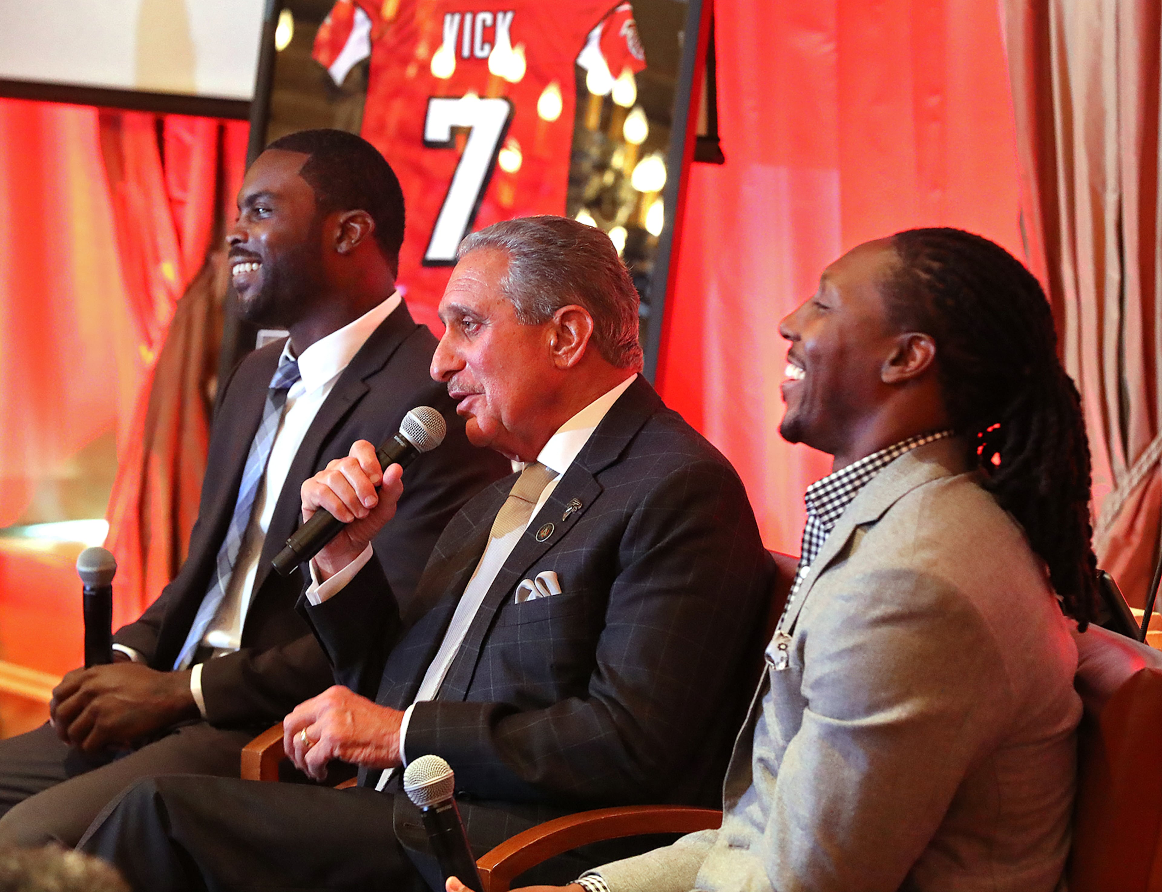 Former Falcons quarterback Michael Vick, owner Arthur Blank and wide receiver Roddy White share a laugh during questions from the media as Vick and White officially retire from the NFL Monday.