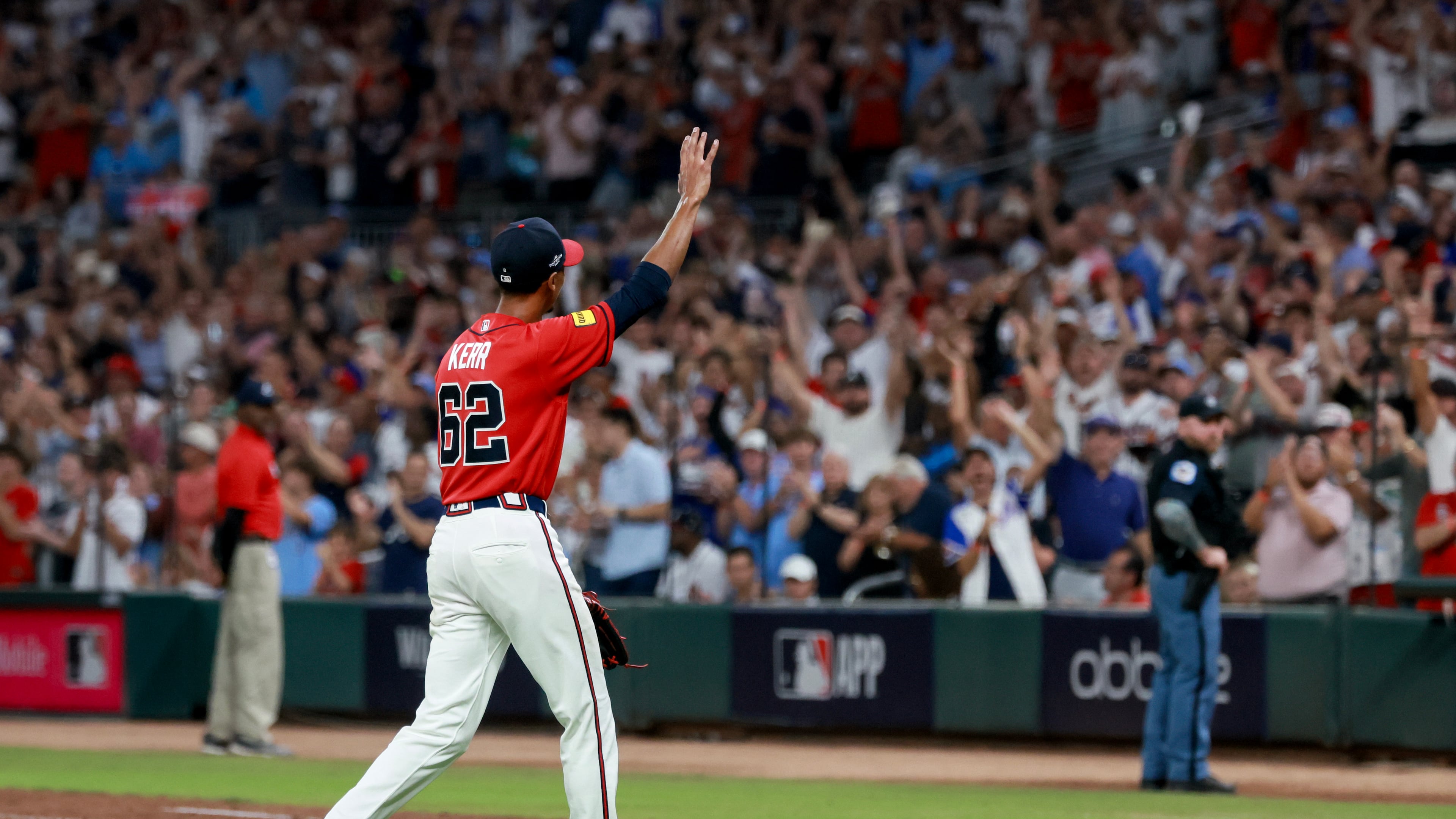 Following his playoff debut, Braves pitcher Ray Kerr waves to the fans at Truist Park after being relieved during Game 3 of their NL Wild Card Series against the Phillies on Thursday, Oct. 1, 2026, in Atlanta. The 32-year-old gave his team 3⅓ scoreless innings as its starter. (Jason Getz/AJC)