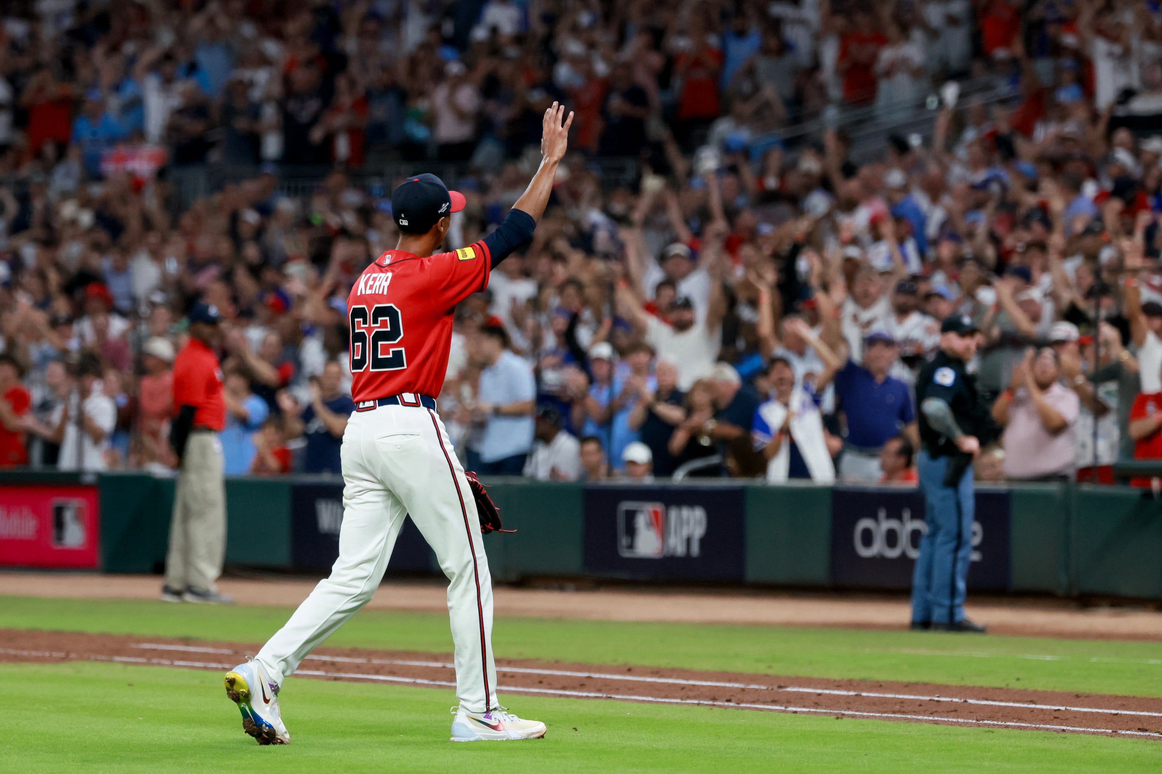 Following his playoff debut, Braves pitcher Ray Kerr waves to the fans at Truist Park after being relieved during Game 3 of their NL Wild Card Series against the Phillies on Thursday, Oct. 1, 2026, in Atlanta. The 32-year-old gave his team 3⅓ scoreless innings as its starter. (Jason Getz/AJC)