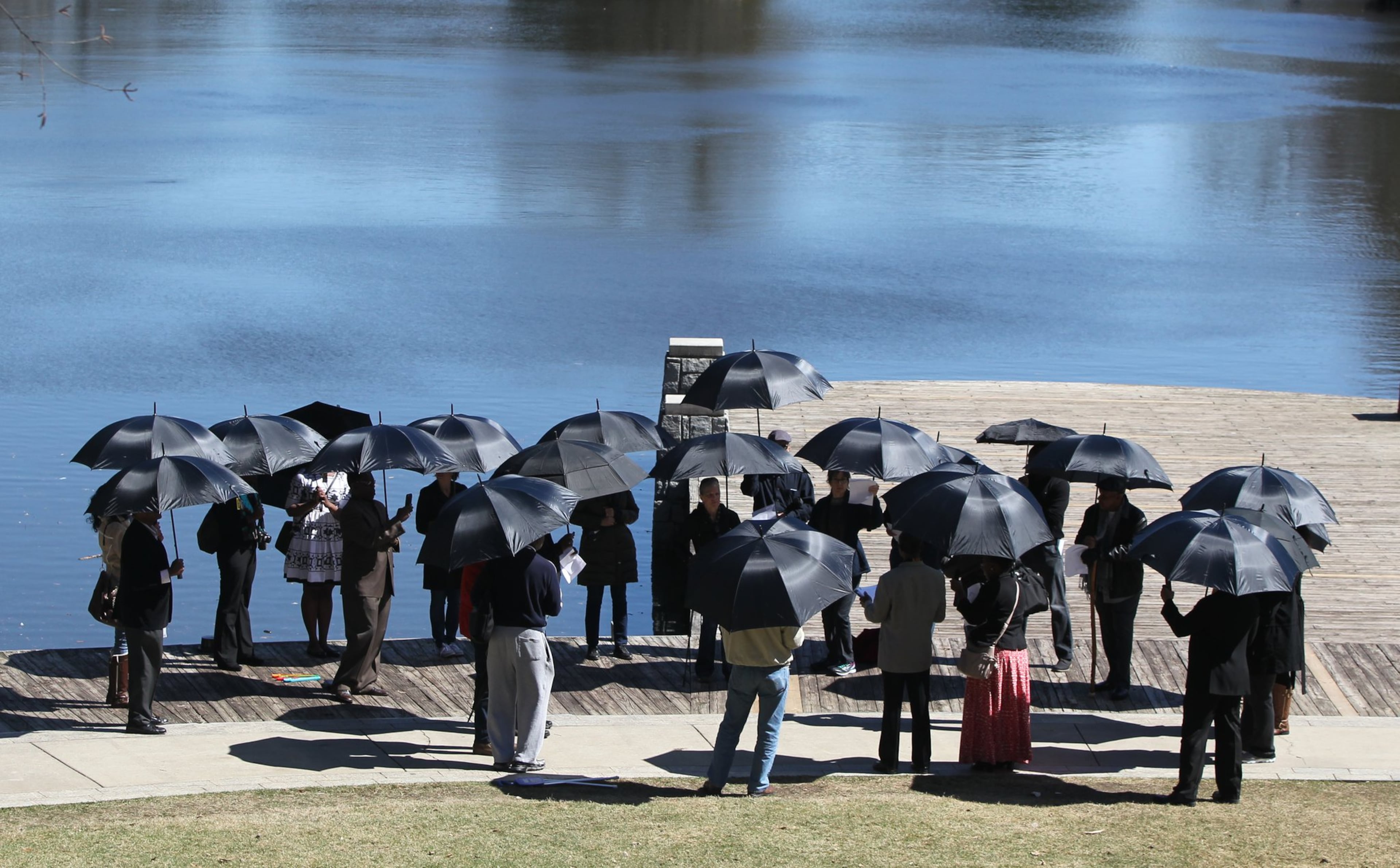 Organizers hold up black umbrellas in Atlanta on March 3, 2017, during a commemoration of the 158th anniversary of the largest sale of human beings in U.S. history. On March 2, 1859, 436 people were sold at an auction in Savannah. It is called “The Weeping Time” because reports note that the rain continued over the two days the auction happened and only stopped after the last slave walked off the stage.
