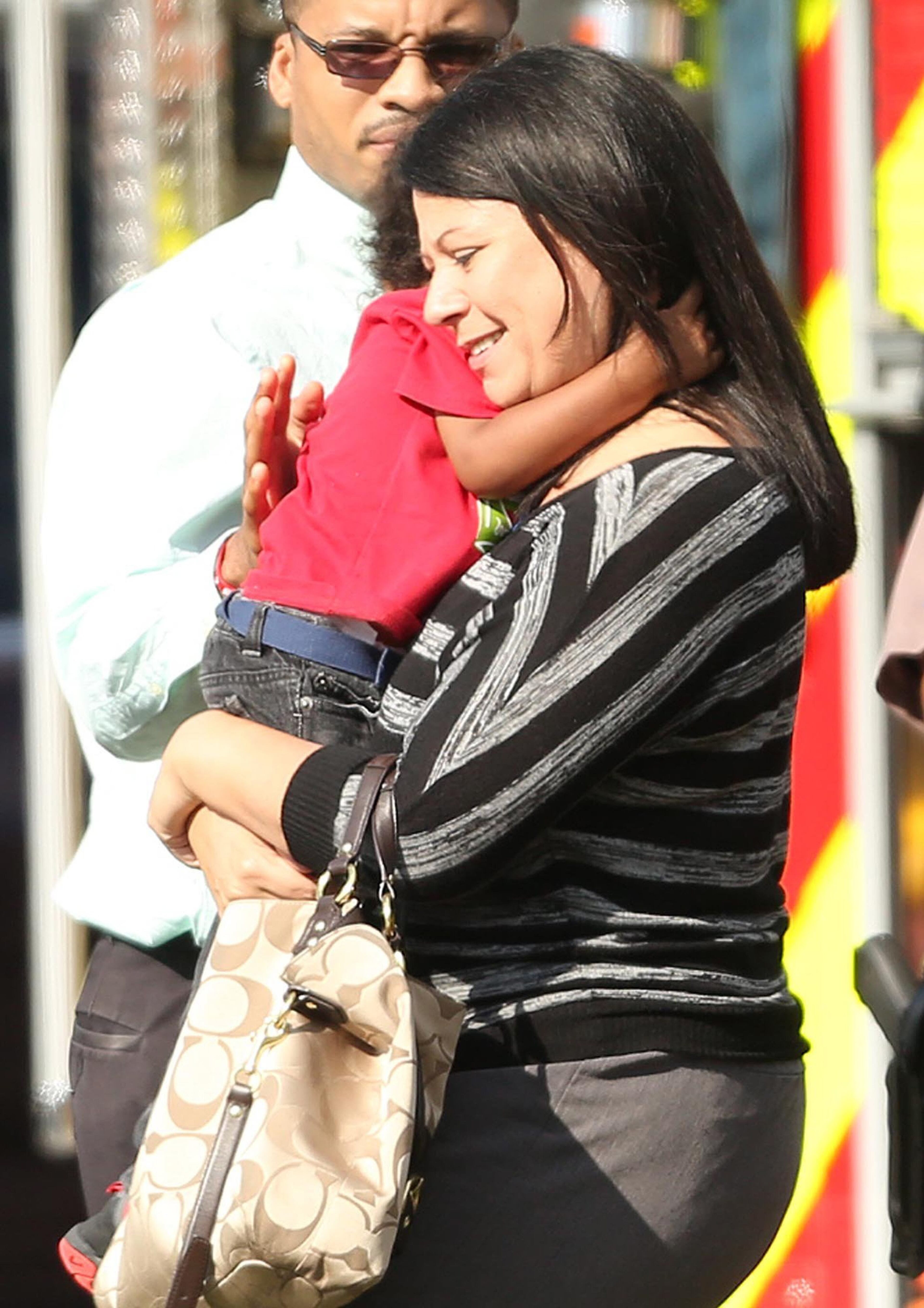 Children are escorted by their parents from the KinderCare Learning Center in Winter Park, Fla., after a car crashed into the facility Wednesday, April 9, 2014. (Stephen M. Dowell, Orlando Sentinel/MCT)