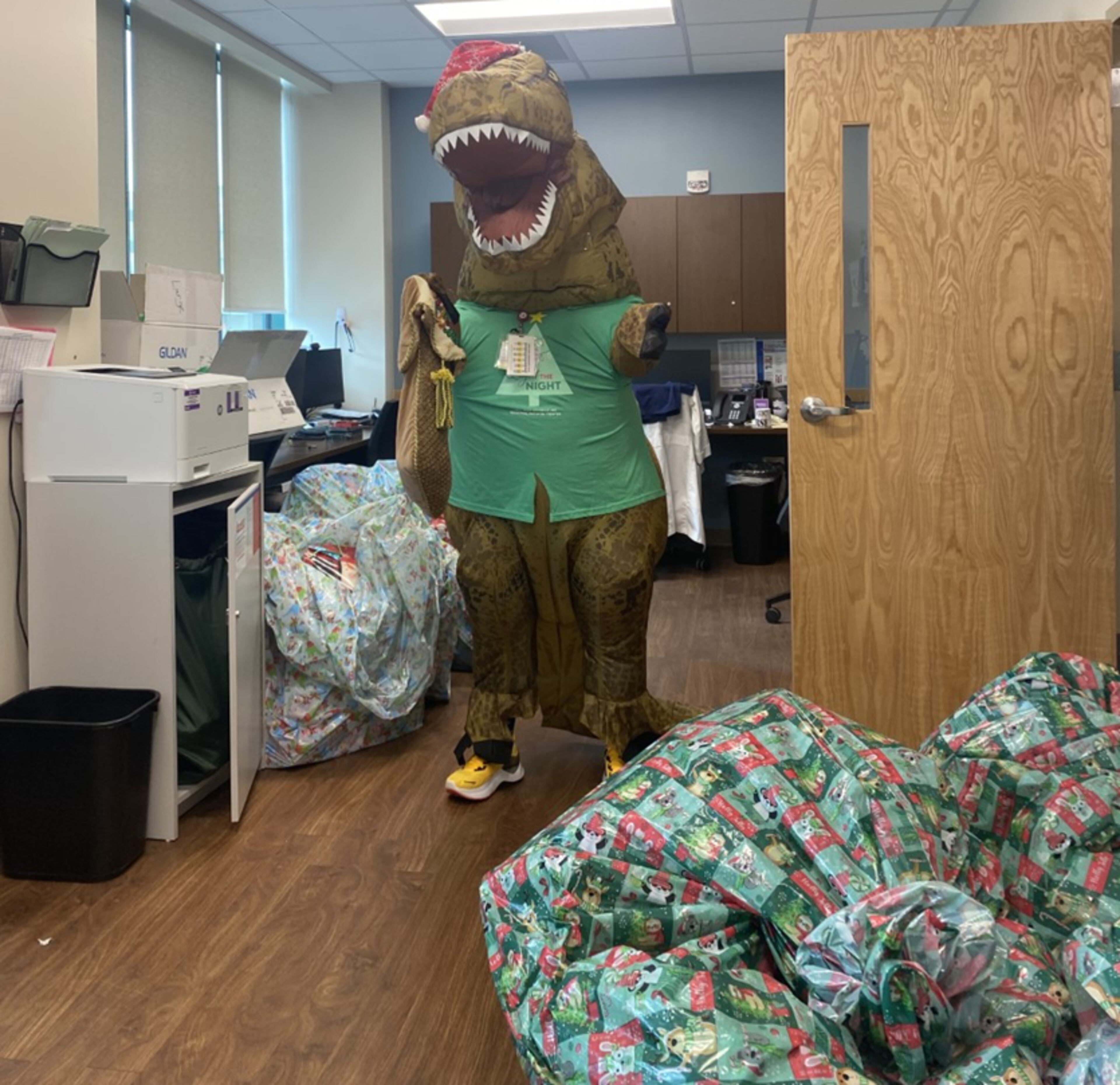 Dino joins staff of the Emergency Department at Wellstar Kennestone Regional Medical Center as they collect gifts as part of a holiday drive in December 2023. Courtesy of Wellstar Kennestone Regional Medical Center