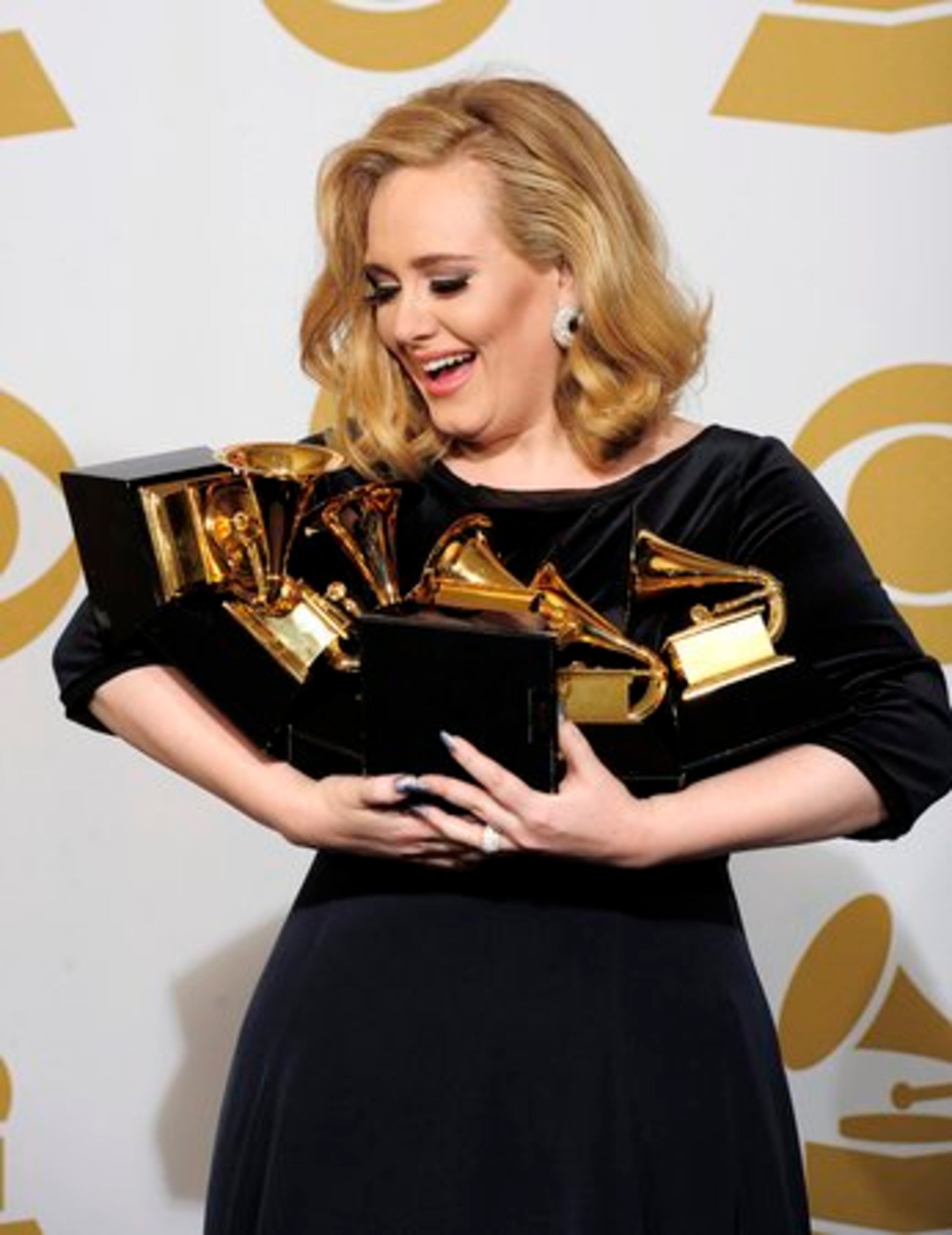 British singer Adele swept the major honors of song, record and album of the year at the 54th annual Grammy Awards show Sunday in Los Angeles. Her total of six Grammys - which she had a hard time cradling - matched Beyonce for most ever by a female act.