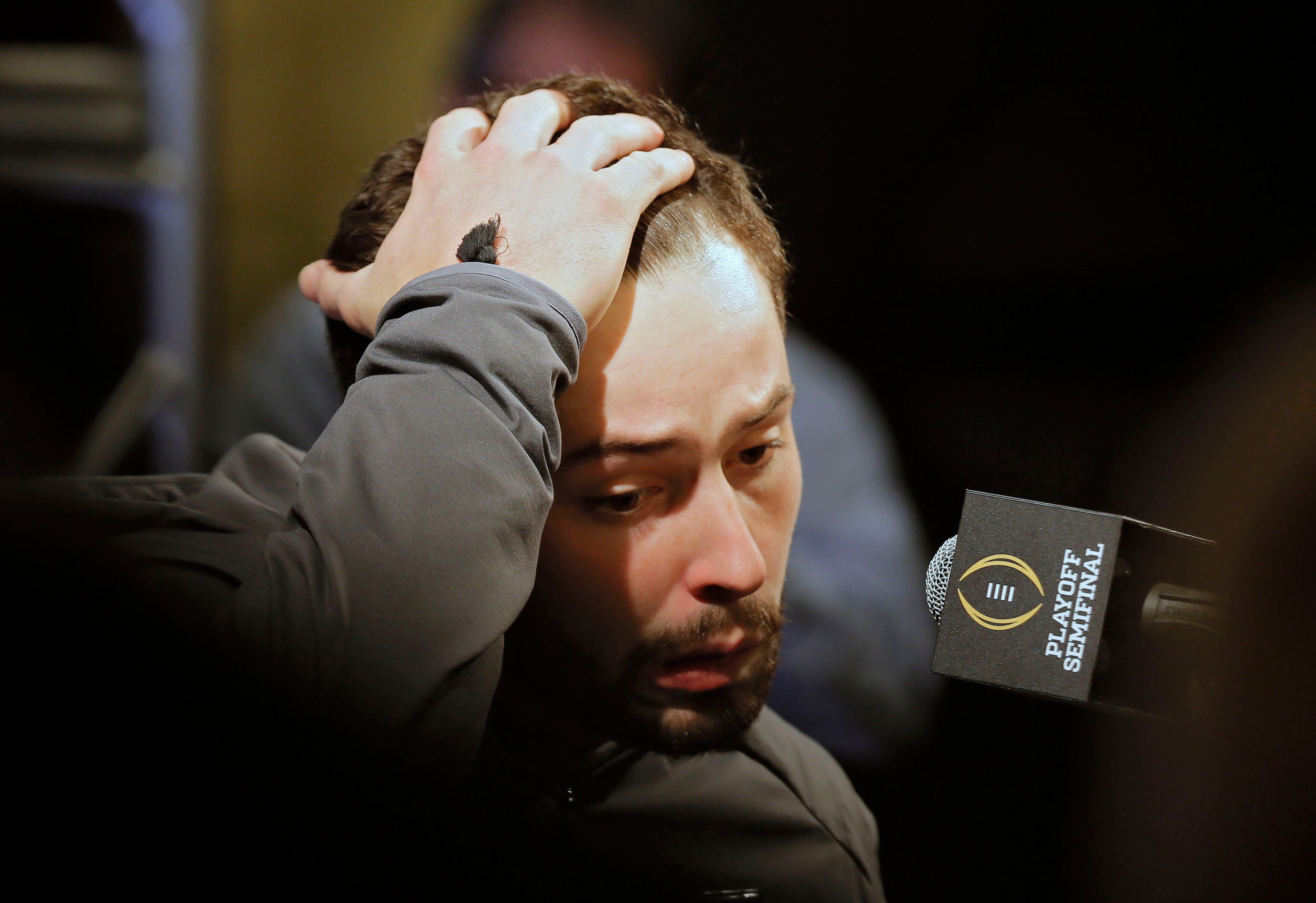 12/30/17 - Los Angeles - A tired looking Baker Mayfield answers questions during his teams media appearance this morning. Oklahoma quarterback Baker Mayfield participated in team media day activities today after arriving late to the event. He reportedly has been recovering from the flu over Christmas break. He missed the trip to Disneyland on Wednesday with the illness and another event on Friday. Oklahoma plays Georgia in a NCAA semifinal playoff game at the Rose Bowl on Monday. BOB ANDRES /BANDRES@AJC.COM