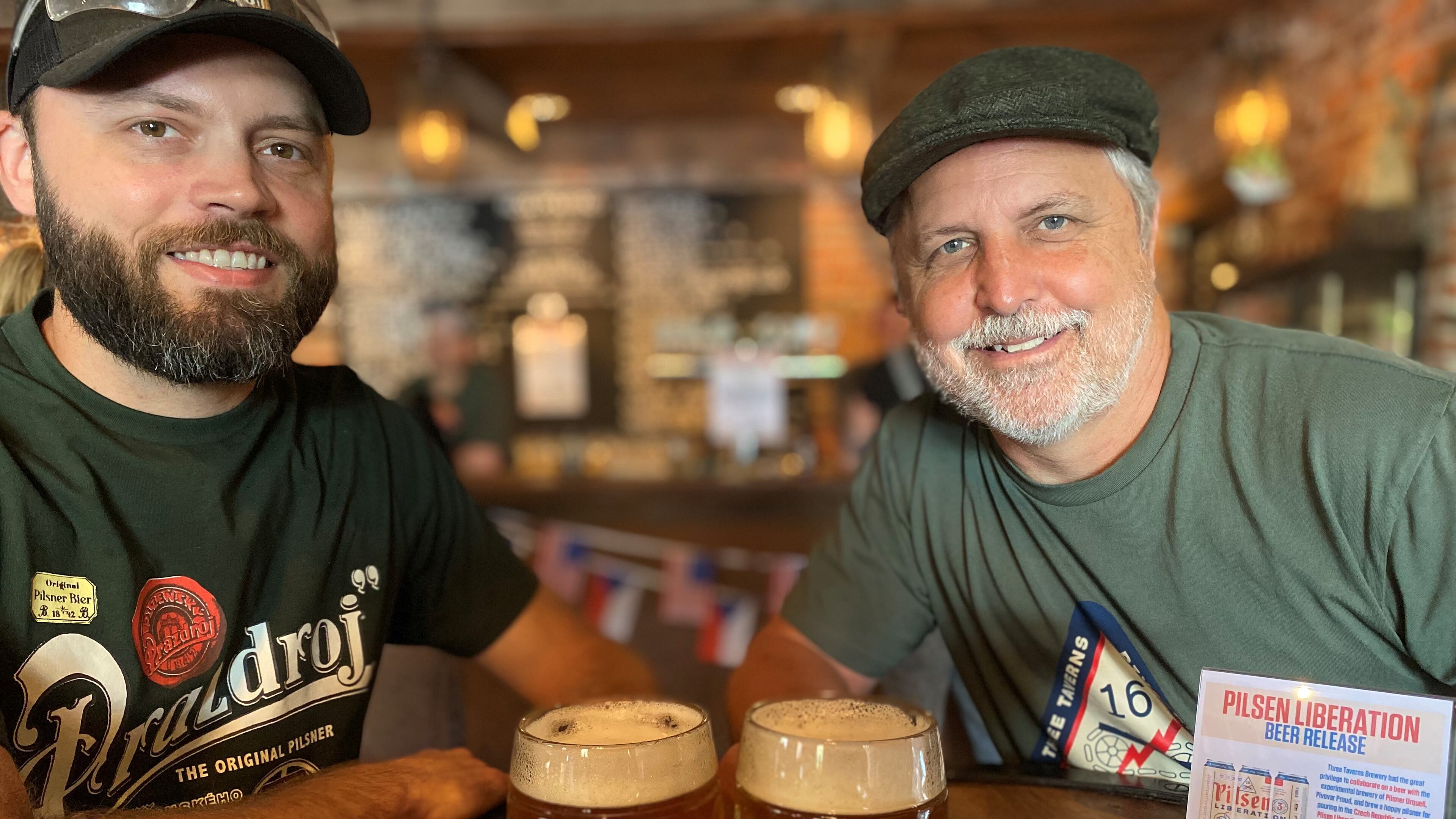 At Three Taverns in Decatur, head brewer Neal Engleman (left) and founder/CEO Brian Purcell share mugs of Pilsen Liberation.
Bob Townsend for The Atlanta Journal-Constitution
