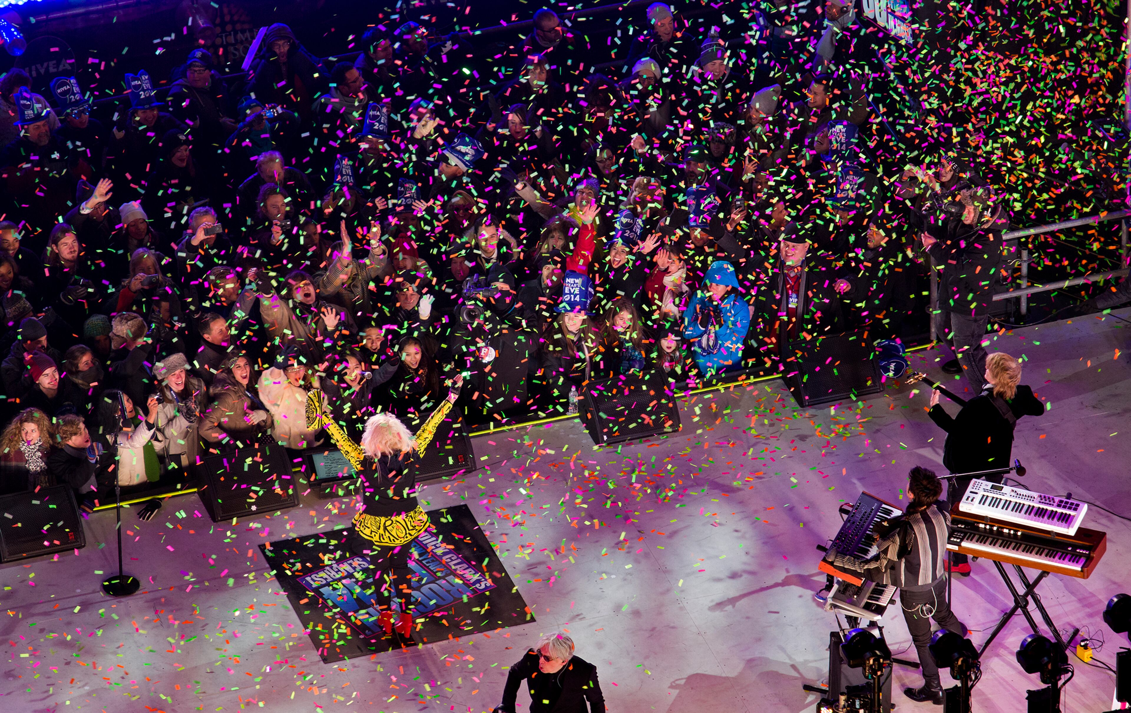 Debbie Harry of Blondie is engulfed in confetti as the band performs during the Times Square New Year's Eve celebrations in New York Tuesday, Dec. 31, 2013. (AP Photo/Craig Ruttle)