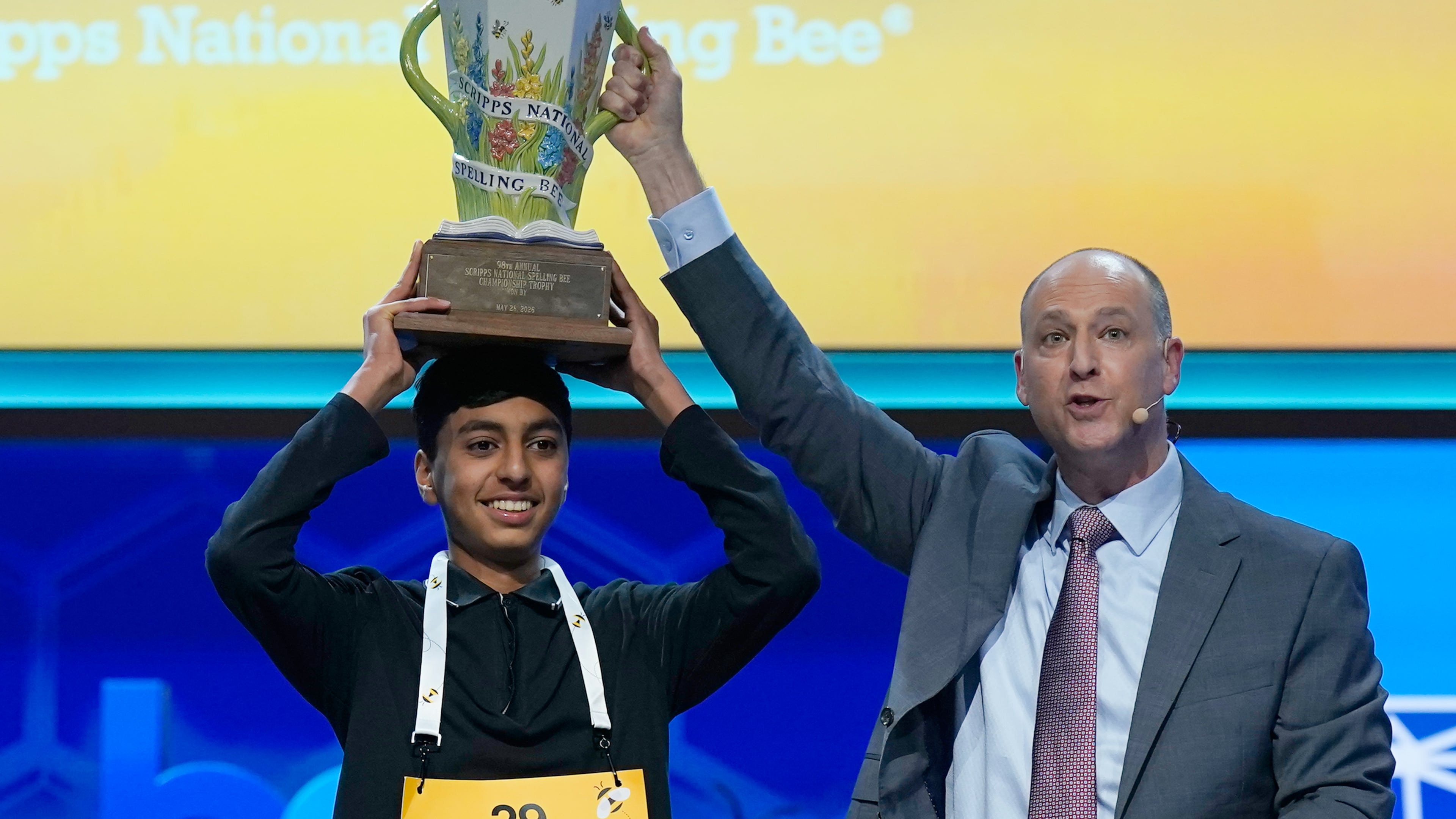 E.W. Scripps Company president and CEO Adam Symson, right, holds the trophy over winner of the 2026 Scripps National Spelling Bee, Shrey Parikh, 14, of Rancho Cucamonga, Calif., at DAR Constitution Hall, Thursday, May 28, 2026, in Washington. (AP Photo/Jose Luis Magana)