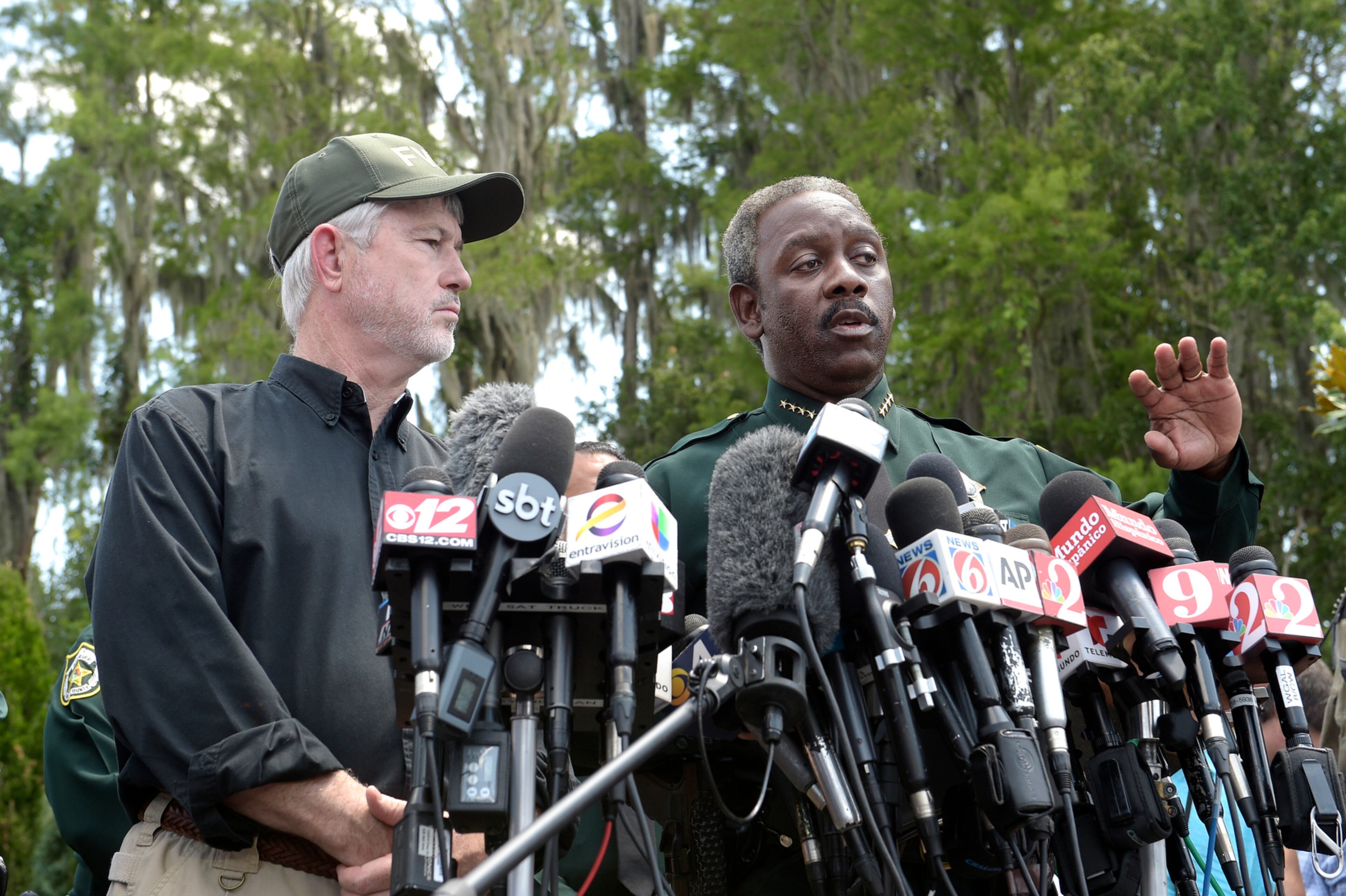 GATOR ATTACK VICTIM FOUND--Nick Wiley, executive director of the Florida Fish & Wildlife Conservation Commission, left, and Orange County Sheriff Jerry Demings answer questions from reporters during a news conference Wednesday, June 15, 2016, in Lake Buena Vista, Fla., after a toddler was dragged into the lake Tuesday evening by an alligator outside Disney's Grand Floridian Resort & Spa. (AP Photo/Phelan M. Ebenhack)