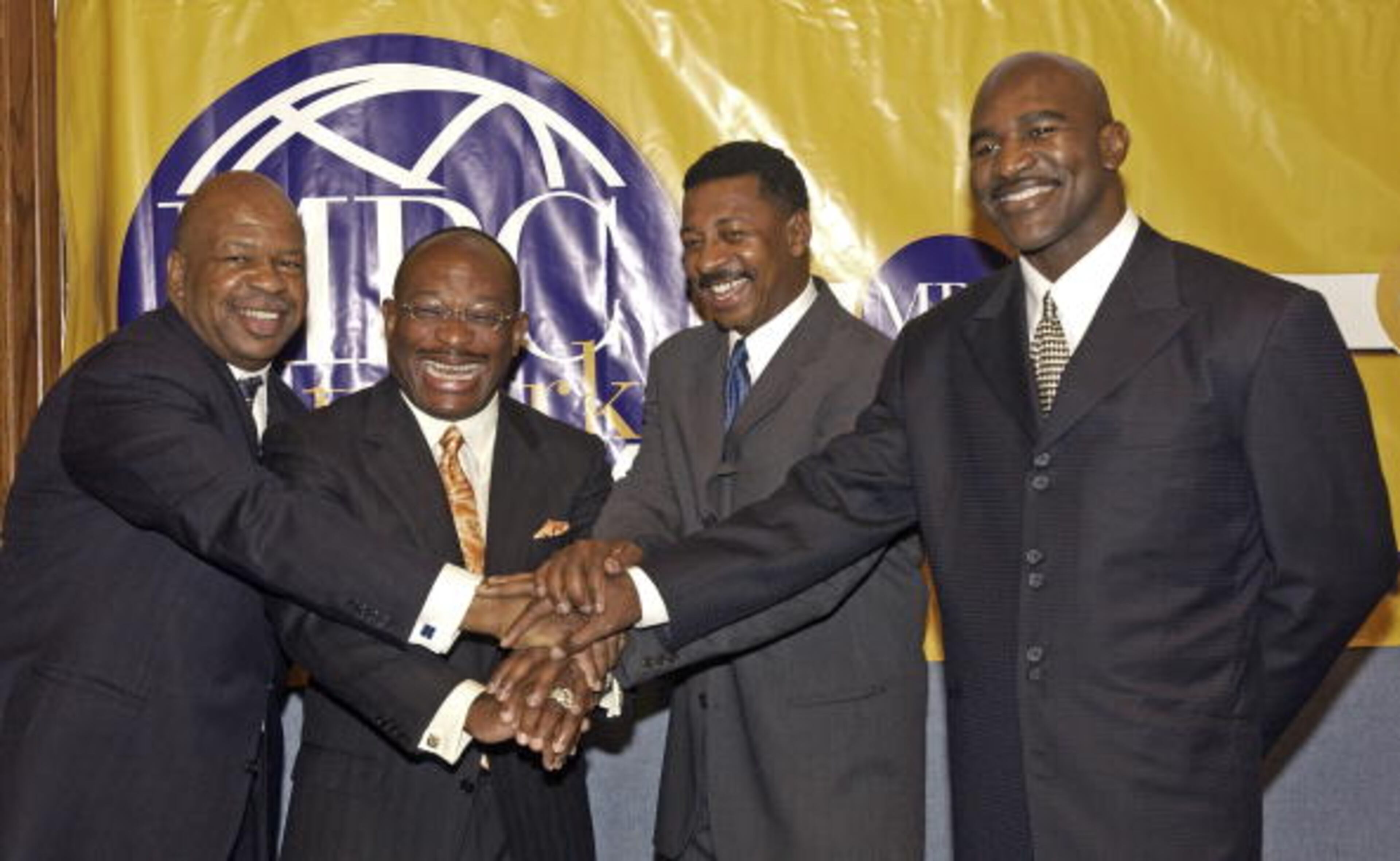 WASHINGTON, DC - MAY 20: (L-R) Rep. Elijah Cummings (D-7th,MD), Willie Gary, CEO of MBC, Robert Townsend, President of MBC Productions and Evander Holyfield, former heavy weight champion pose at an MBC Network news briefing to discuss their unwavering commitment to redefine television by producing innovative and engaging family-friendly programs for black America on May 20, 2004 in Washington, DC. (Photo by Stephen Boitano/Getty Images)