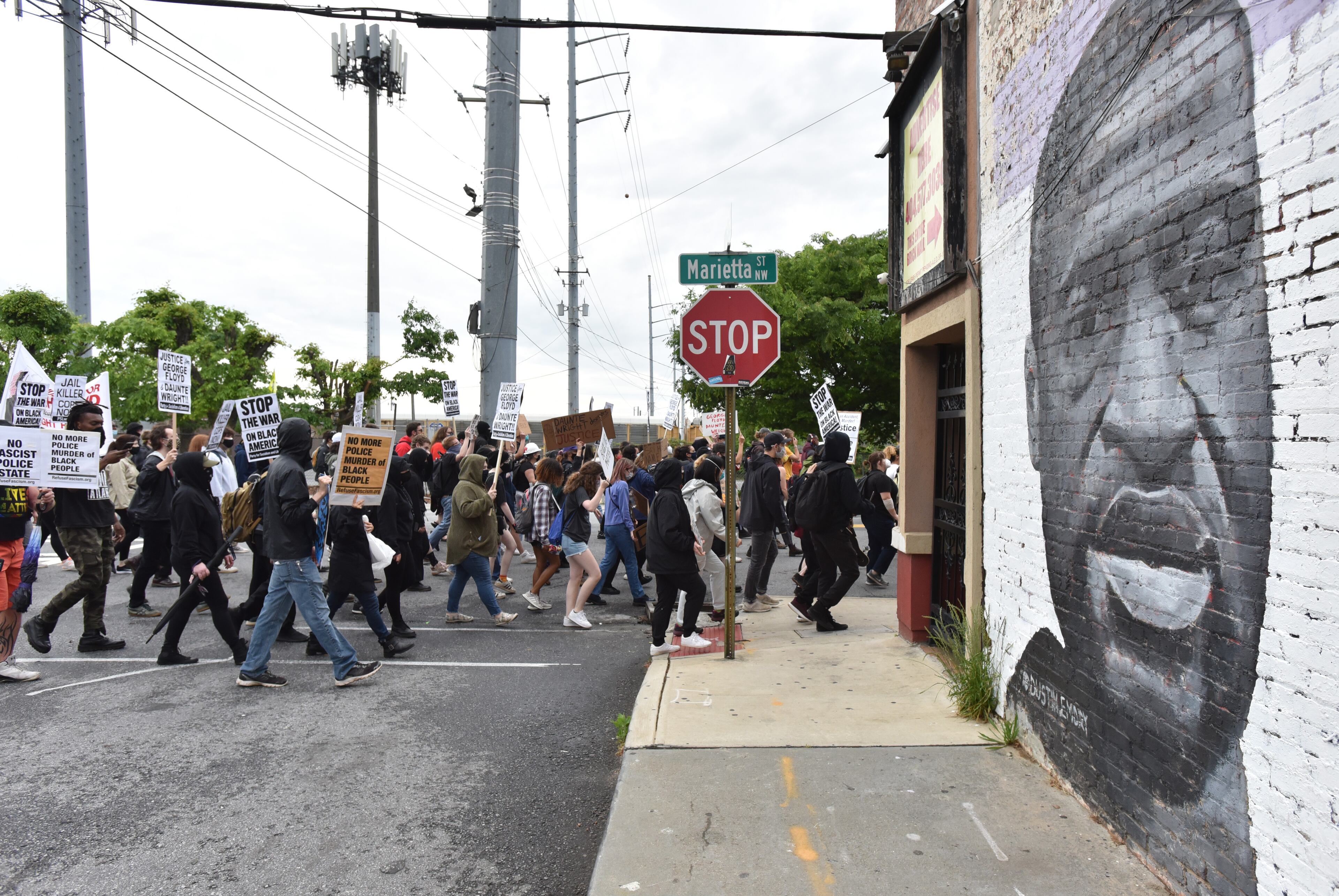 April 14, 2021 Atlanta - Protesters march around the Centennial Olympic Park during a rally in solidarity with Minnesota - Justice for Daunte Wright on Wednesday, April 14, 2021. (Hyosub Shin / Hyosub.Shin@ajc.com)