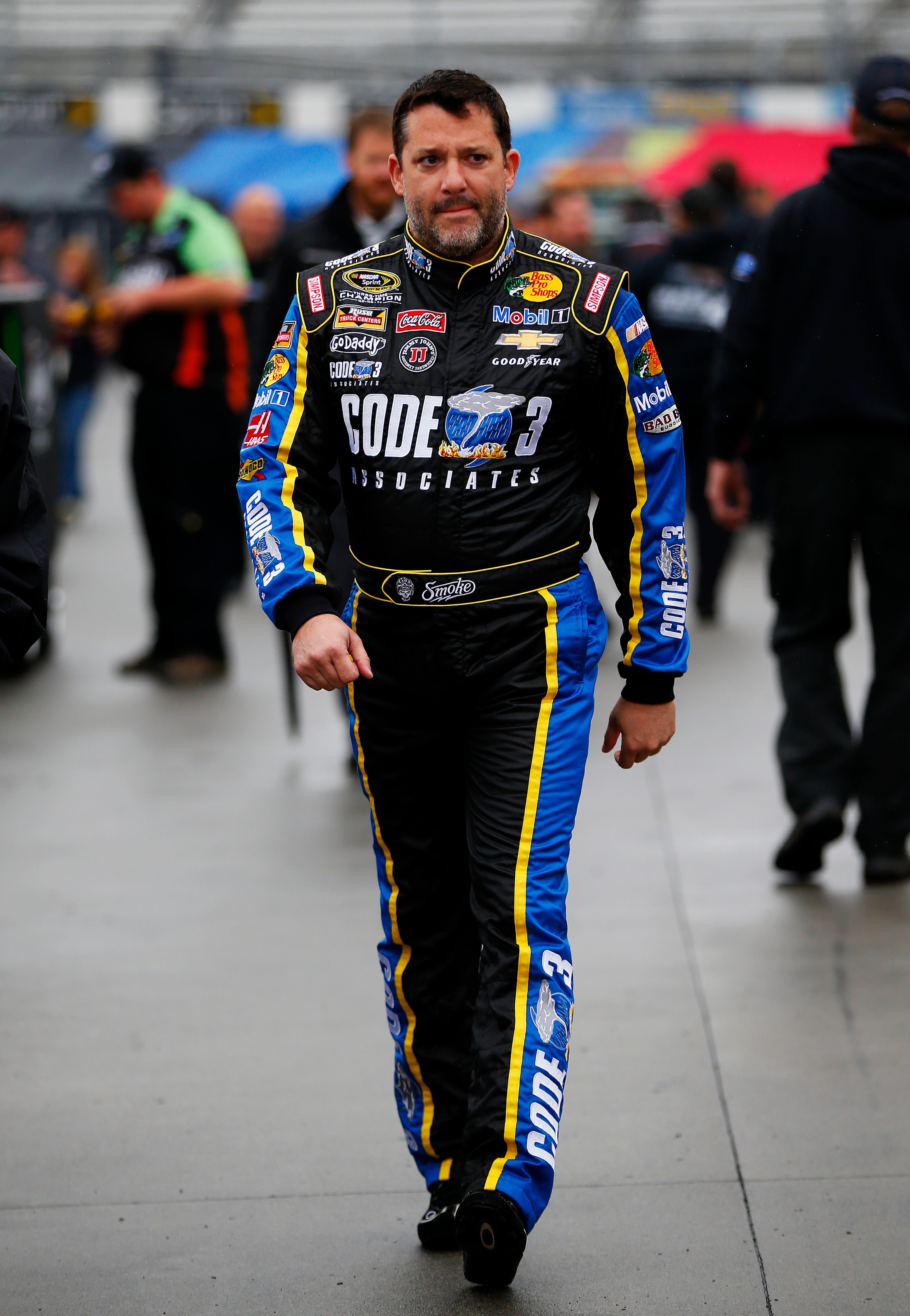 MARTINSVILLE, VA - MARCH 29: Tony Stewart, driver of the #14 Code 3 Associates / Mobil 1 Chevrolet, walks through the garage area during a rain delay in practice for the NASCAR Sprint Cup Series STP 500 at Martinsville Speedway on March 29, 2014 in Martinsville, Virginia. (Photo by Matt Sullivan/Getty Images)