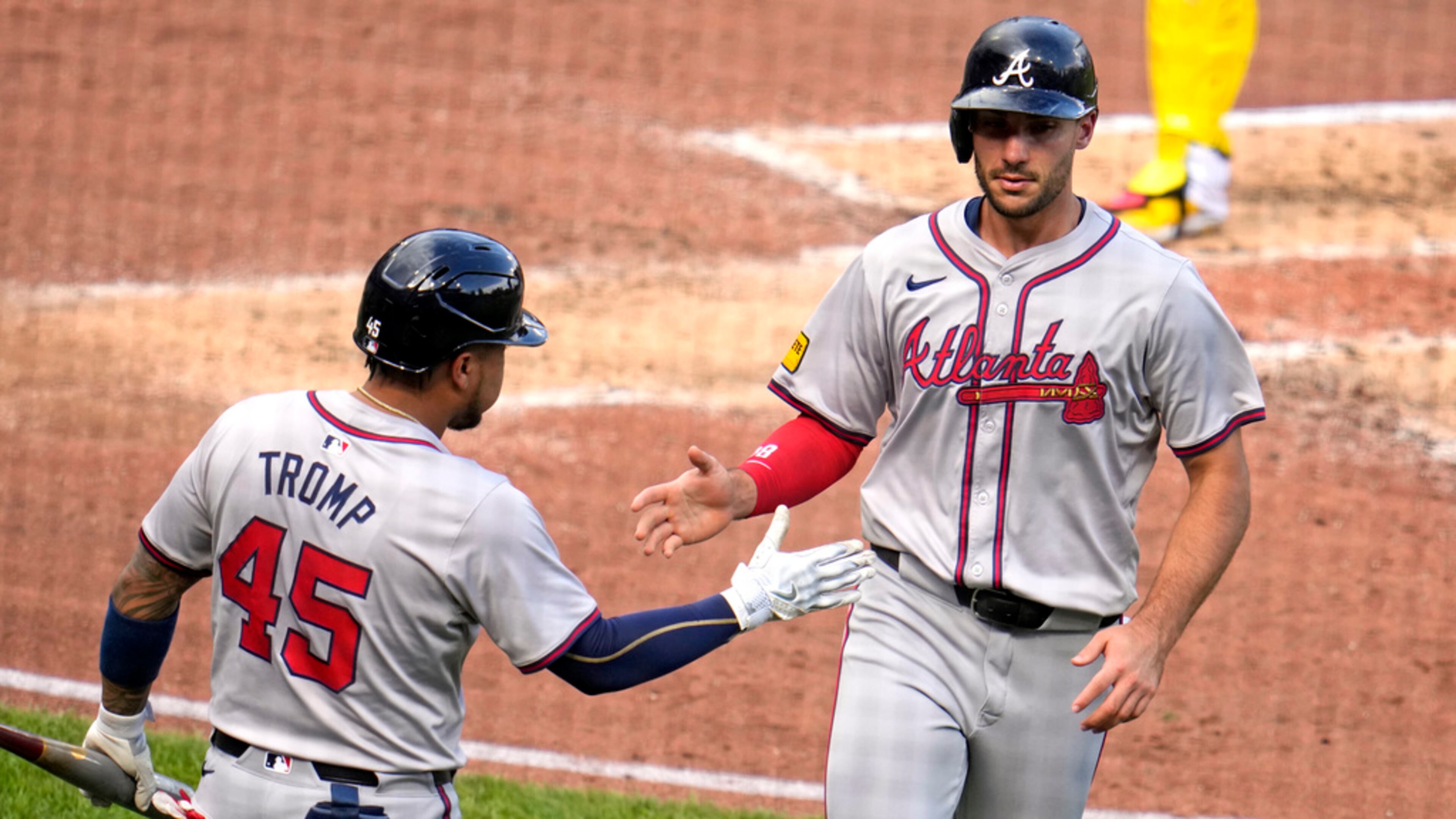 Atlanta Braves' Matt Olson, right, is greeted by Chadwick Tromp after scoring on a single by Jarred Kelenic off Pittsburgh Pirates starting pitcher Mitch Keller during the fourth inning of a baseball game in Pittsburgh, Saturday, May 25, 2024. (AP Photo/Gene J. Puskar)
