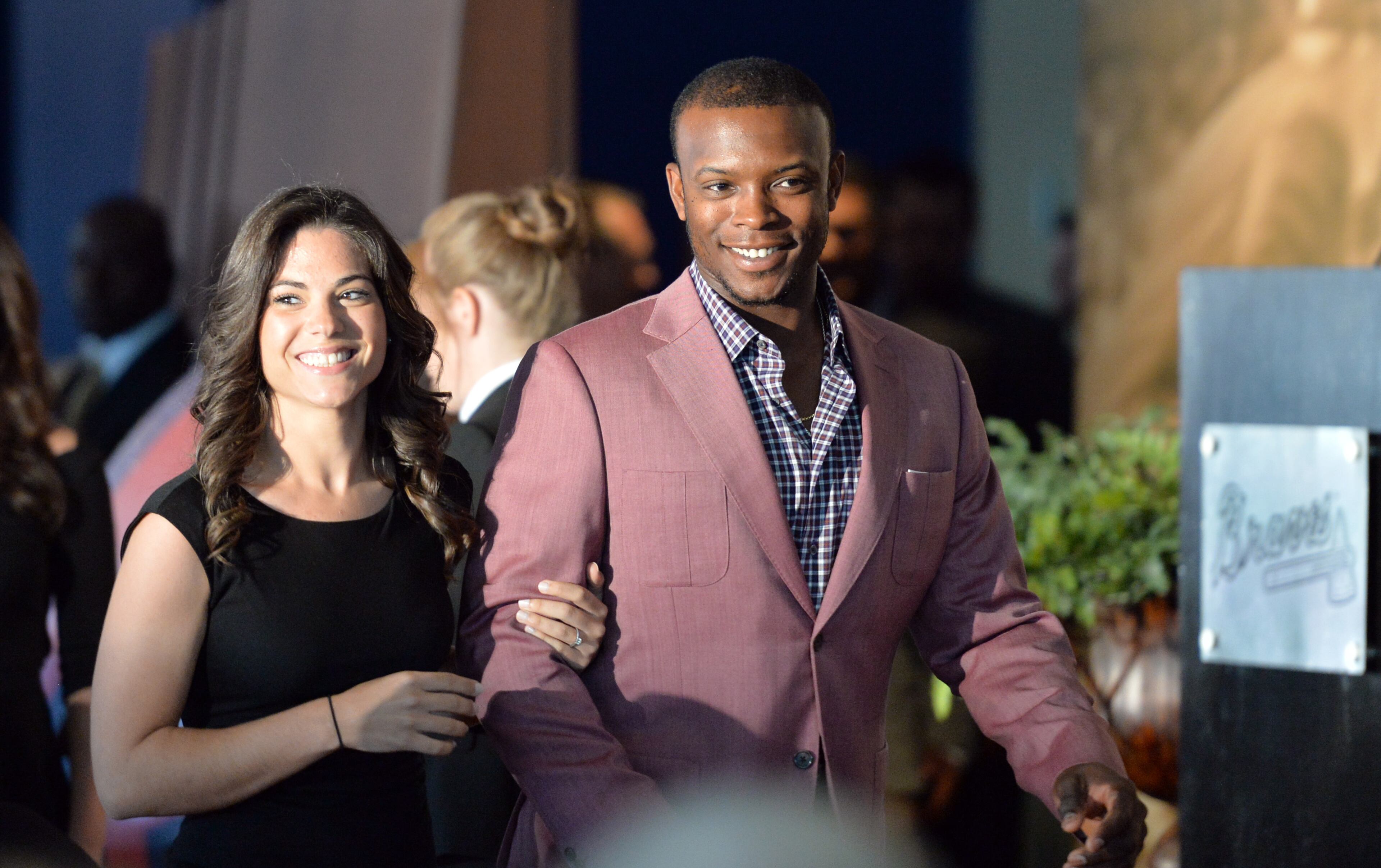 Braves outfielder Justin Upton is escorted to his seat.