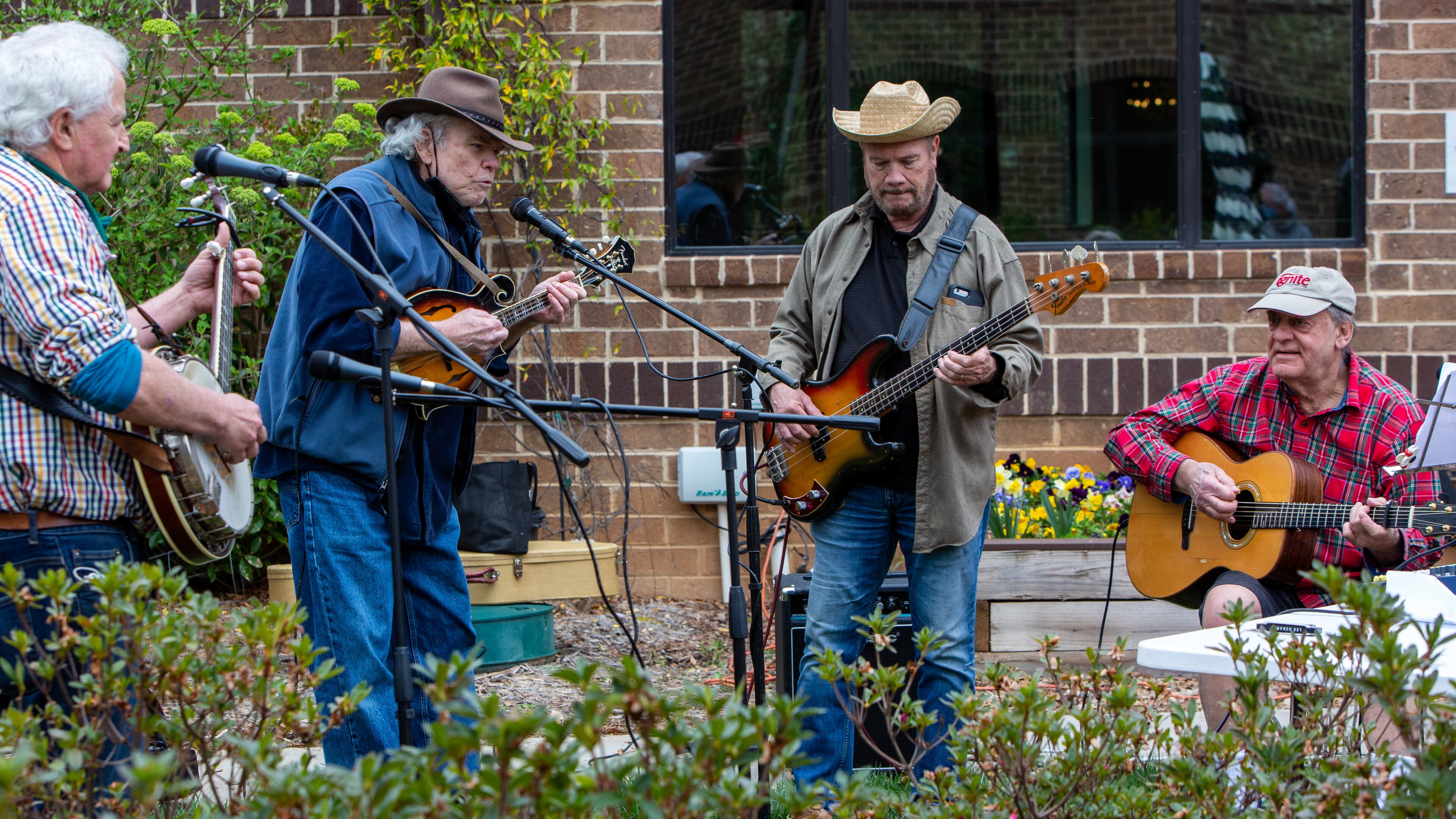 The Druid Hills Billys, Paul Parker (from left), Jim Culliton, Dave Cooper and Skip Romaner, perform at Clairmont Place in Decatur. The band, made up of physicians in the area, which regularly played at Clairmont Place before the pandemic, kept it up and increased performances during the lockdown. They played outdoors with residents listening from their balconies. PHIL SKINNER FOR THE ATLANTA JOURNAL-CONSTITUTION.