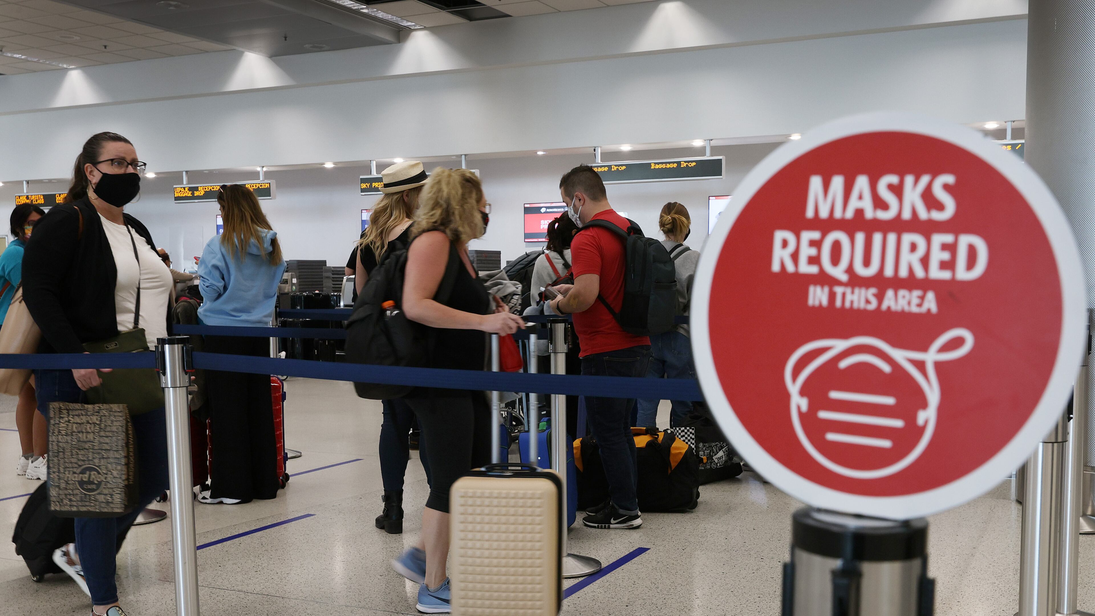 A sign reading, 'masks required in this area,' is seen as travelers prepare to check-in for their Delta Air Lines flight at the Miami International Airport on Feb. 1, 2021 in Miami, Florida. (Joe Raedle/Getty Images/TNS)