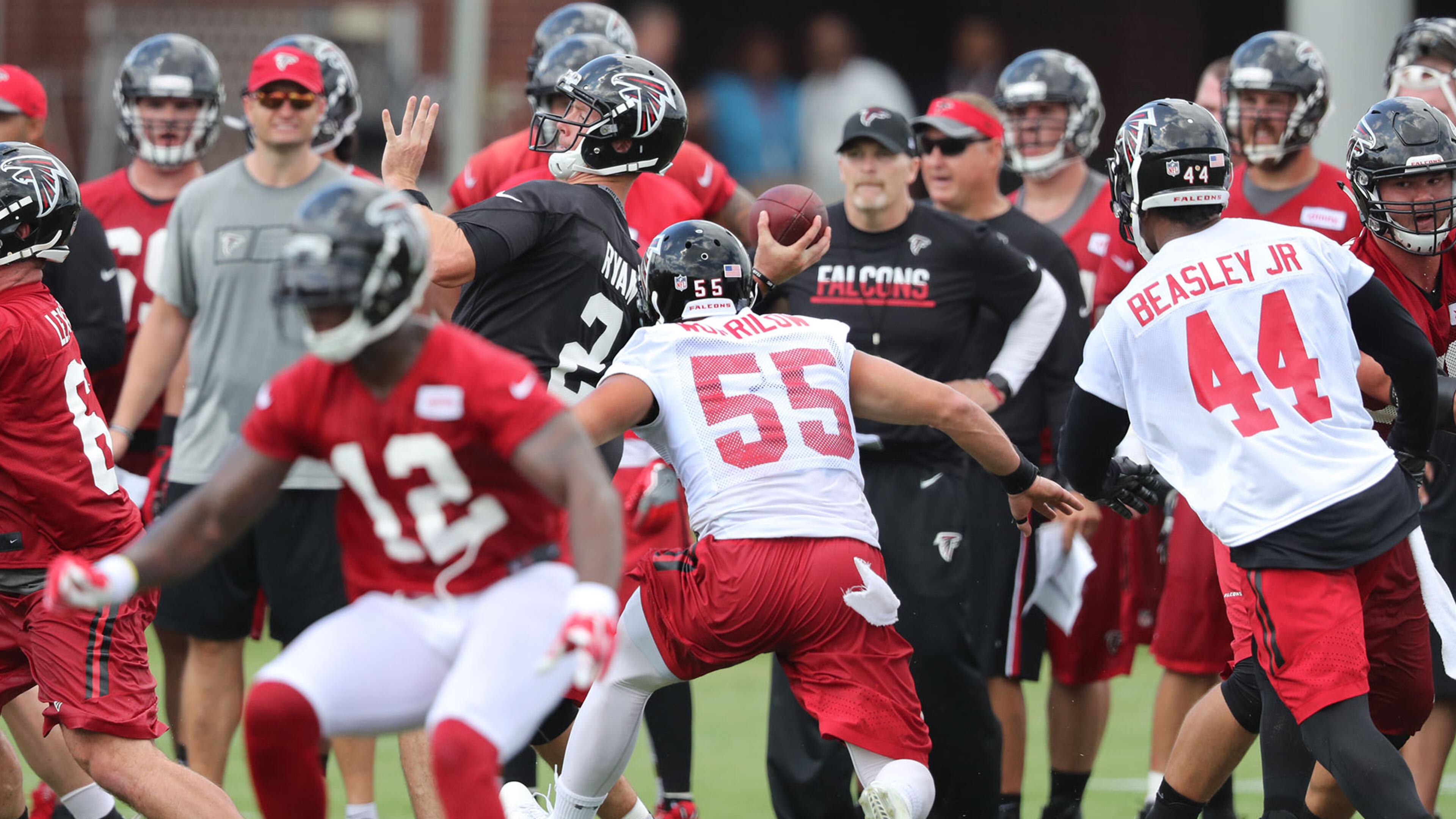 Falcons head coach Dan Quinn (background) knows he needs to get more from the pass rush this season, including Vic Beasley Jr. (right). (Curtis Compton /ccompton@ajc.com)