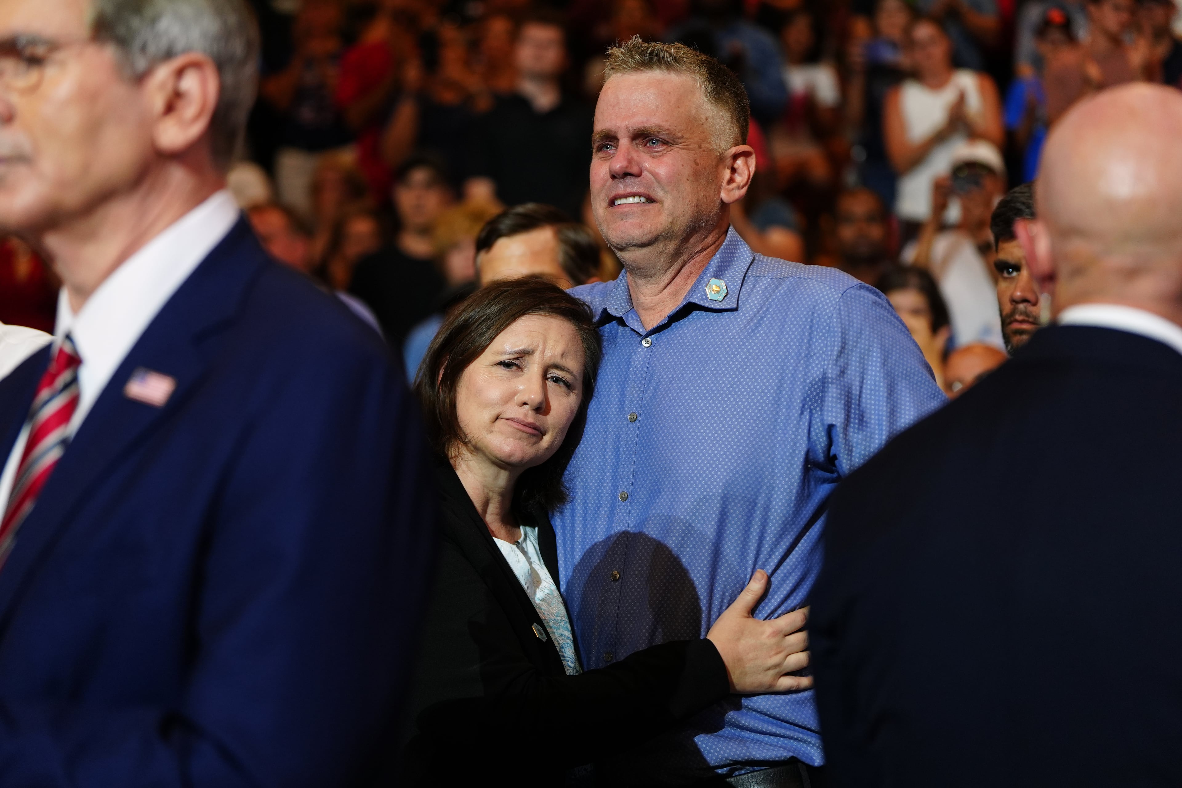 Shari and Stephen Feehan, the parents of 1st Lt. Tyler James Feehan, are understandably emotional as the president talks about their son at Wheeler High School on July 22, 2026. (Julia Demaree Nikhinson/AP)
