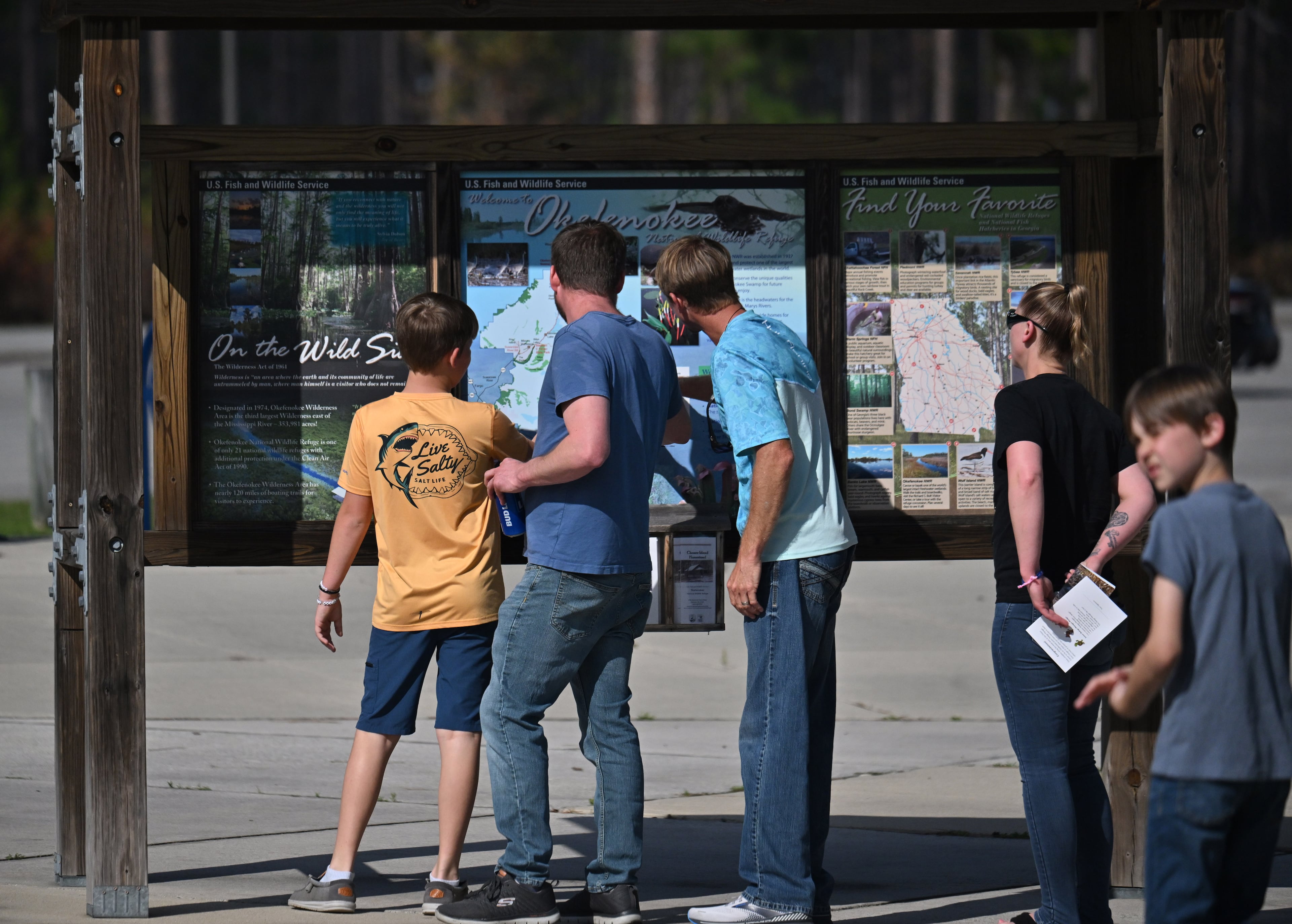 Visitors check out maps near the Suwannee Canal Recreation Area in the Okefenokee National Wildlife Refuge on Monday, March 18, 2024, in Folkston. (Hyosub Shin/AJC)