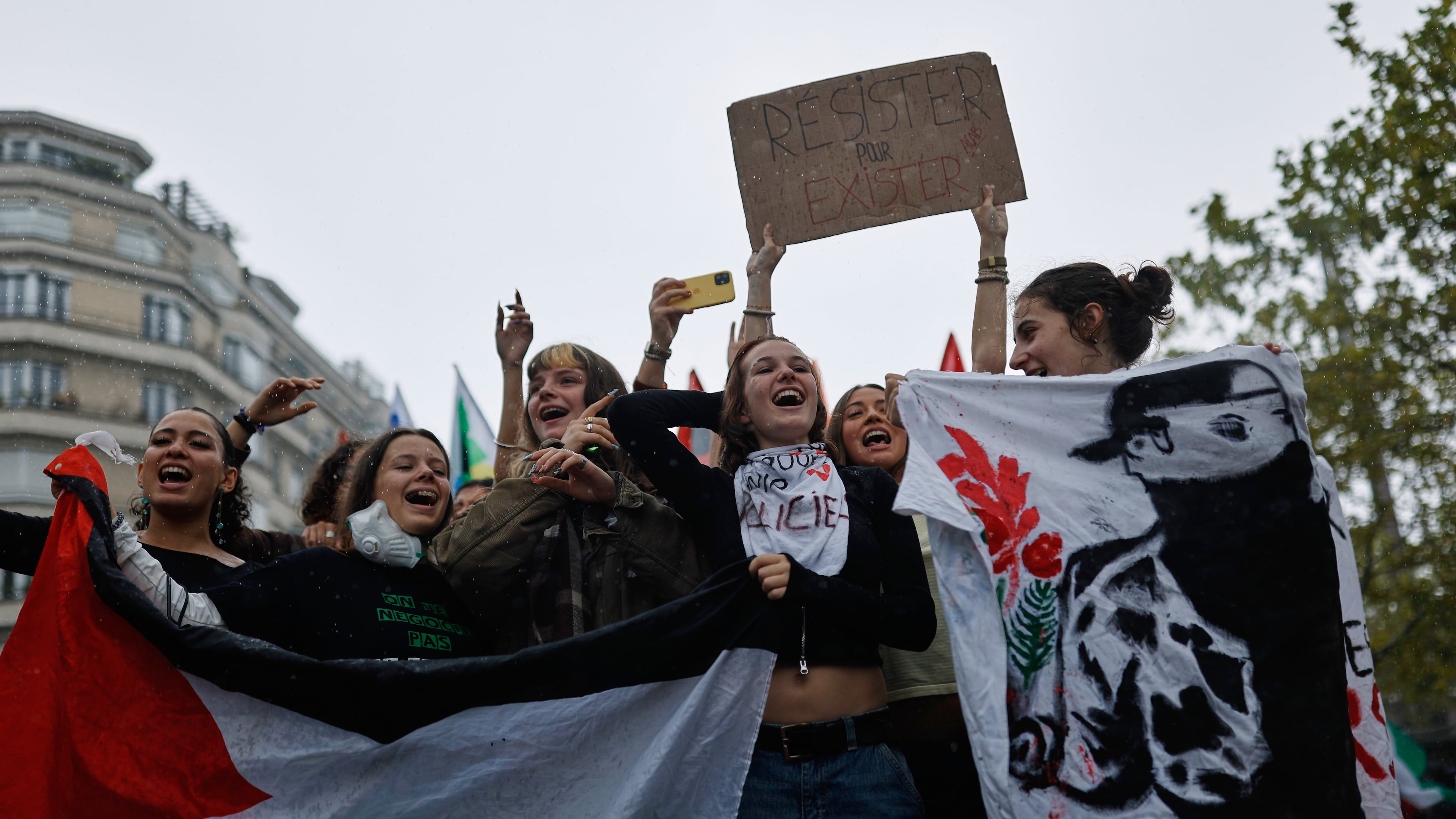 Students chant during a protest against under-resourced schools in Rennes, France, Tuesday, Oct. 13, 2026. The placard reads: "resist to exist." (AP Photo/Jeremias Gonzalez)
