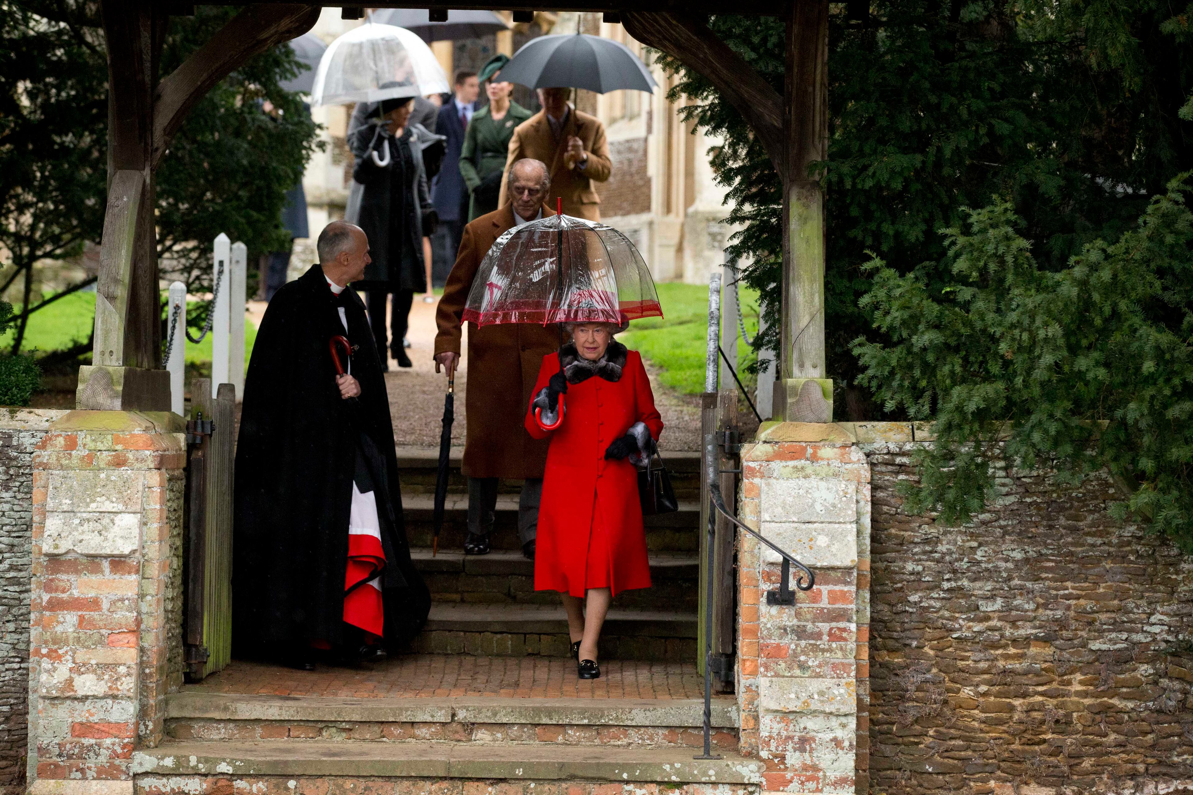 Britain's Queen Elizabeth II and her husband Prince Philip, behind her, leave after attending the British royal family's traditional Christmas Day church service at St. Mary Magdalene Church in Sandringham, England, Friday, Dec. 25, 2015. (AP Photo/Matt Dunham)