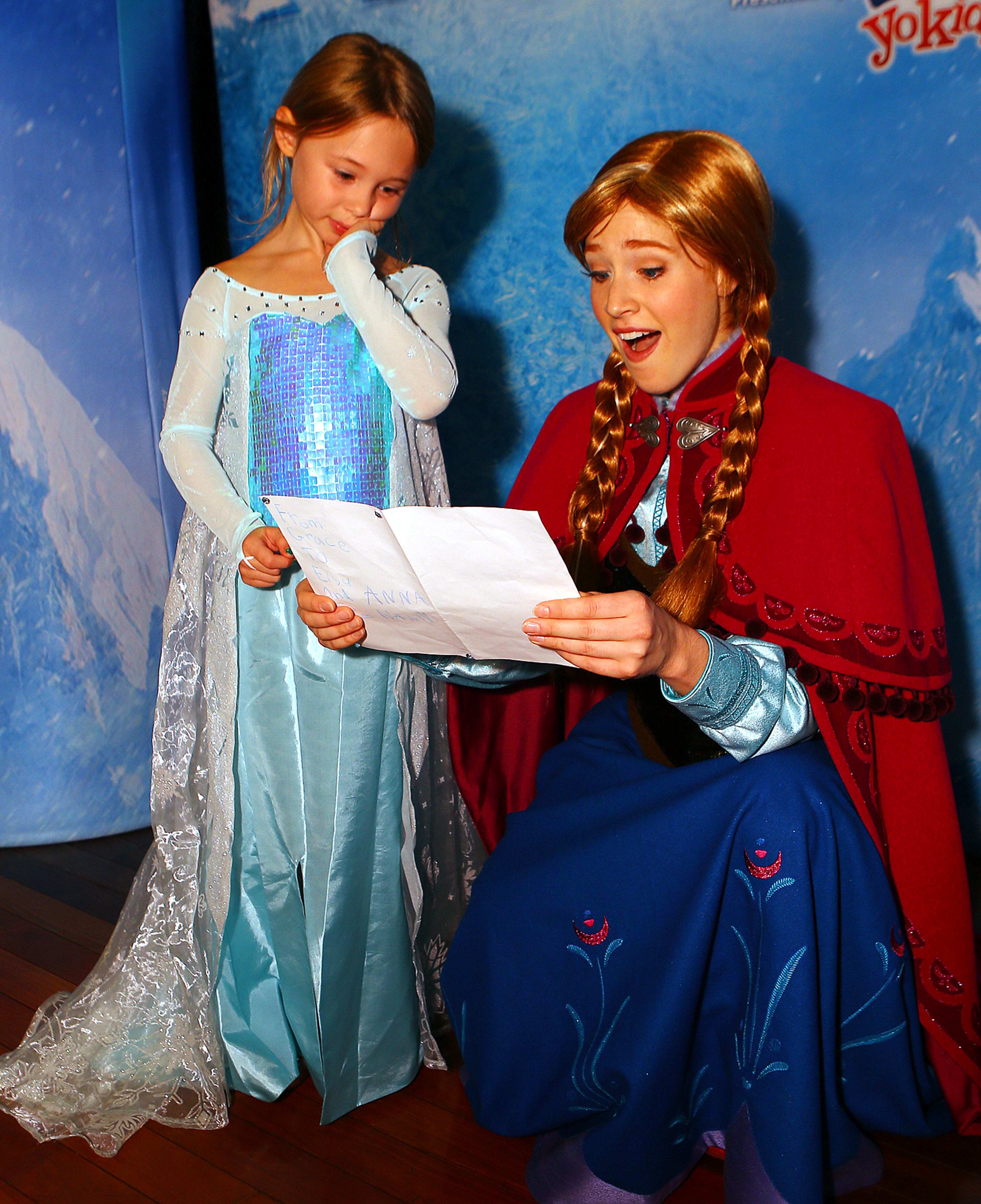 Grace Hopkins, 5, Marietta, gives her idol royal princess Anna a hand drawn card during the meet and greet/blue carpet for Disney On Ice presents Frozen at Philips Arena on Wednesday, Oct. 8, 2014, in Atlanta.