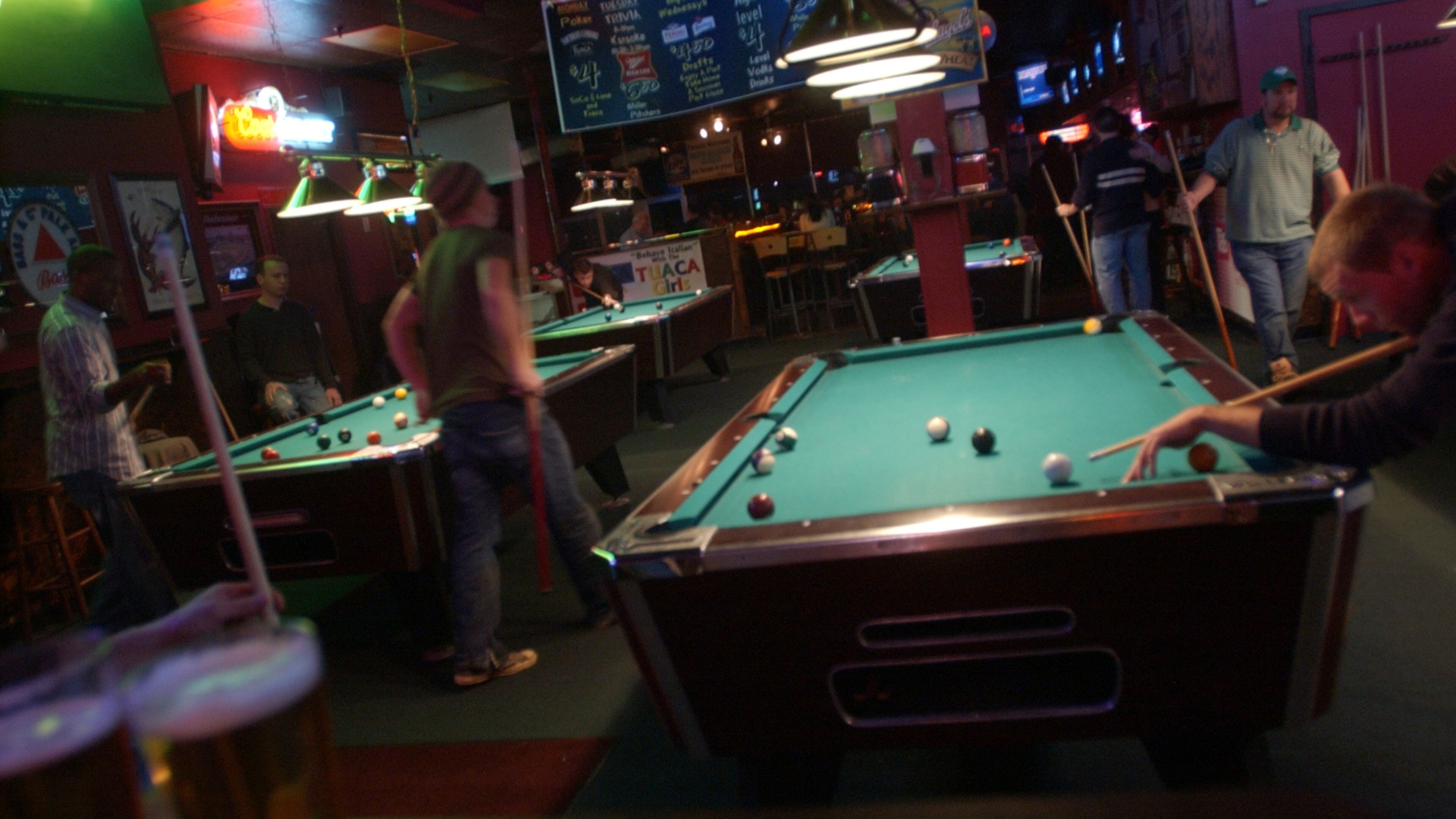 Patrons play pool at Famous Pub. / AJC file photo