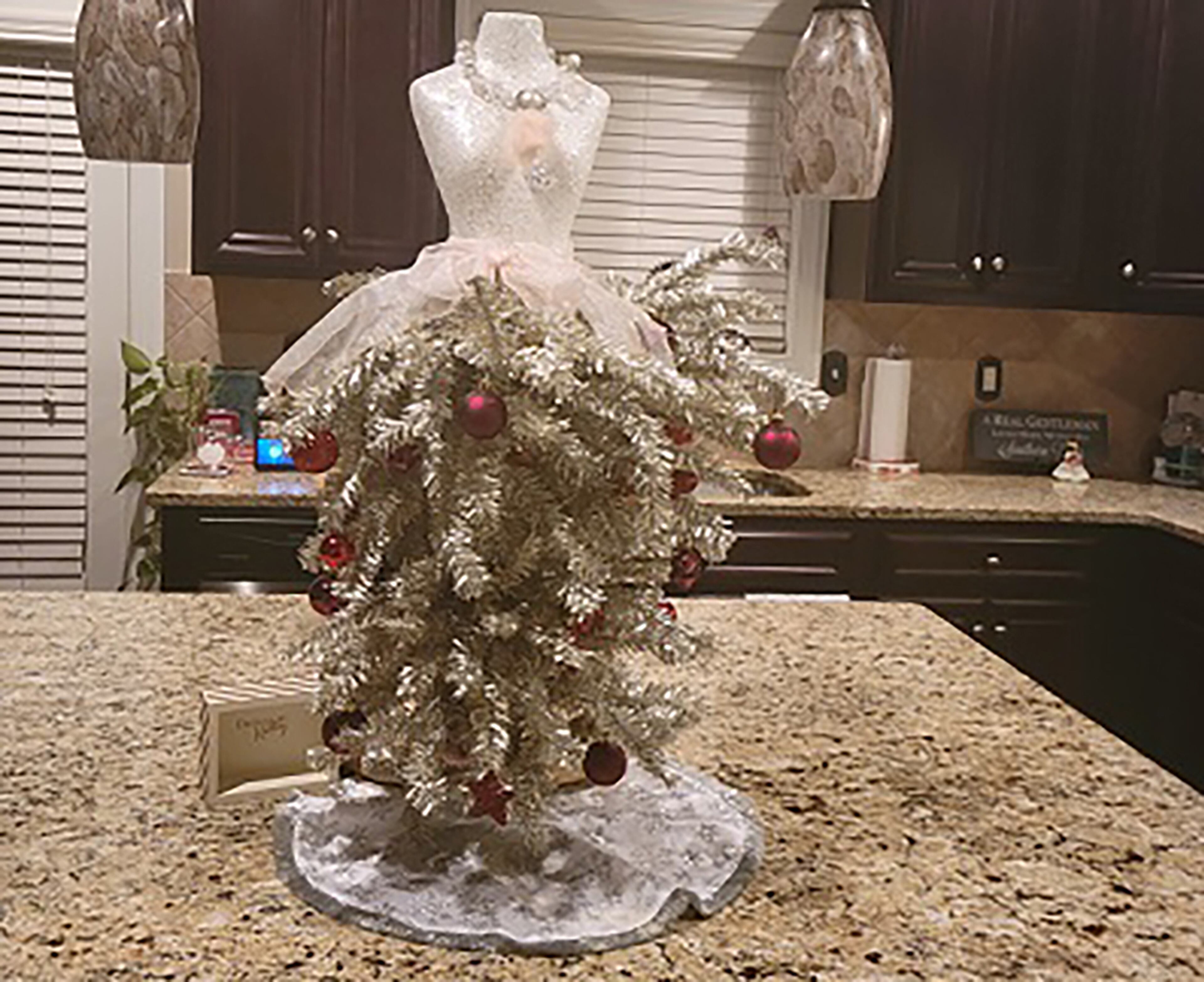 Cato family in Conyers "LOVES the holidays and the warm happy spirit it brings. We put Christmas trees everywhere there is room," Kelly Cato said. The trees are all coordinated by color and holiday spirit. This one is in their kitchen.