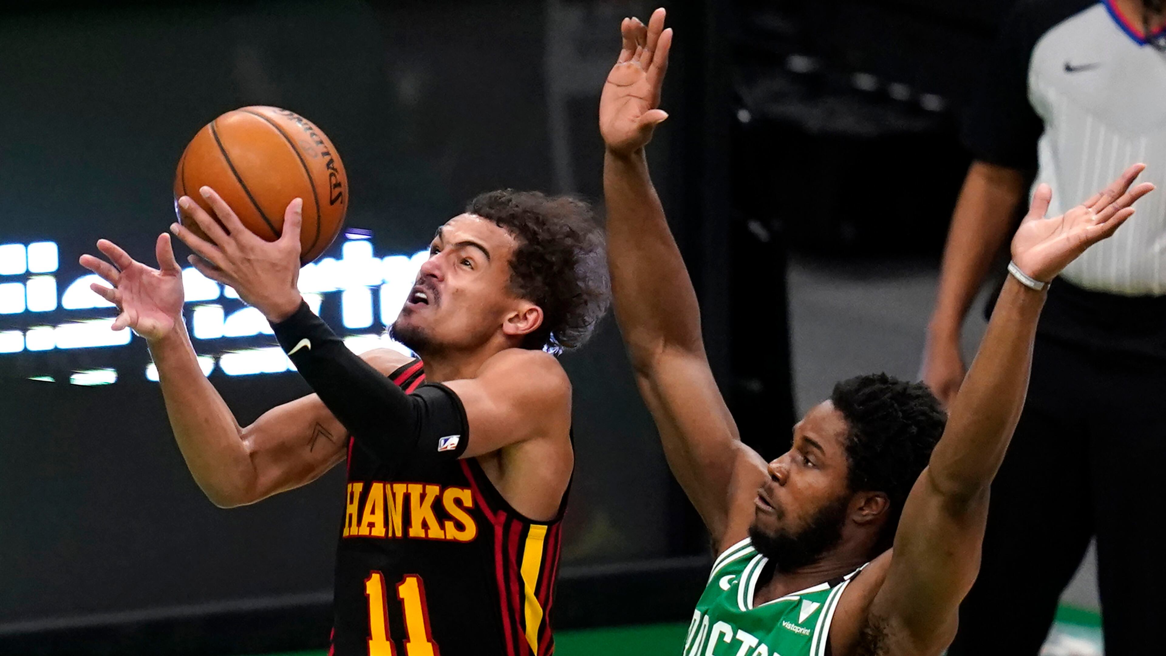 Atlanta Hawks guard Trae Young (11) drives past Boston Celtics forward Semi Ojeleye during the second half of an NBA basketball game, Wednesday, Feb. 17, 2021, in Boston.