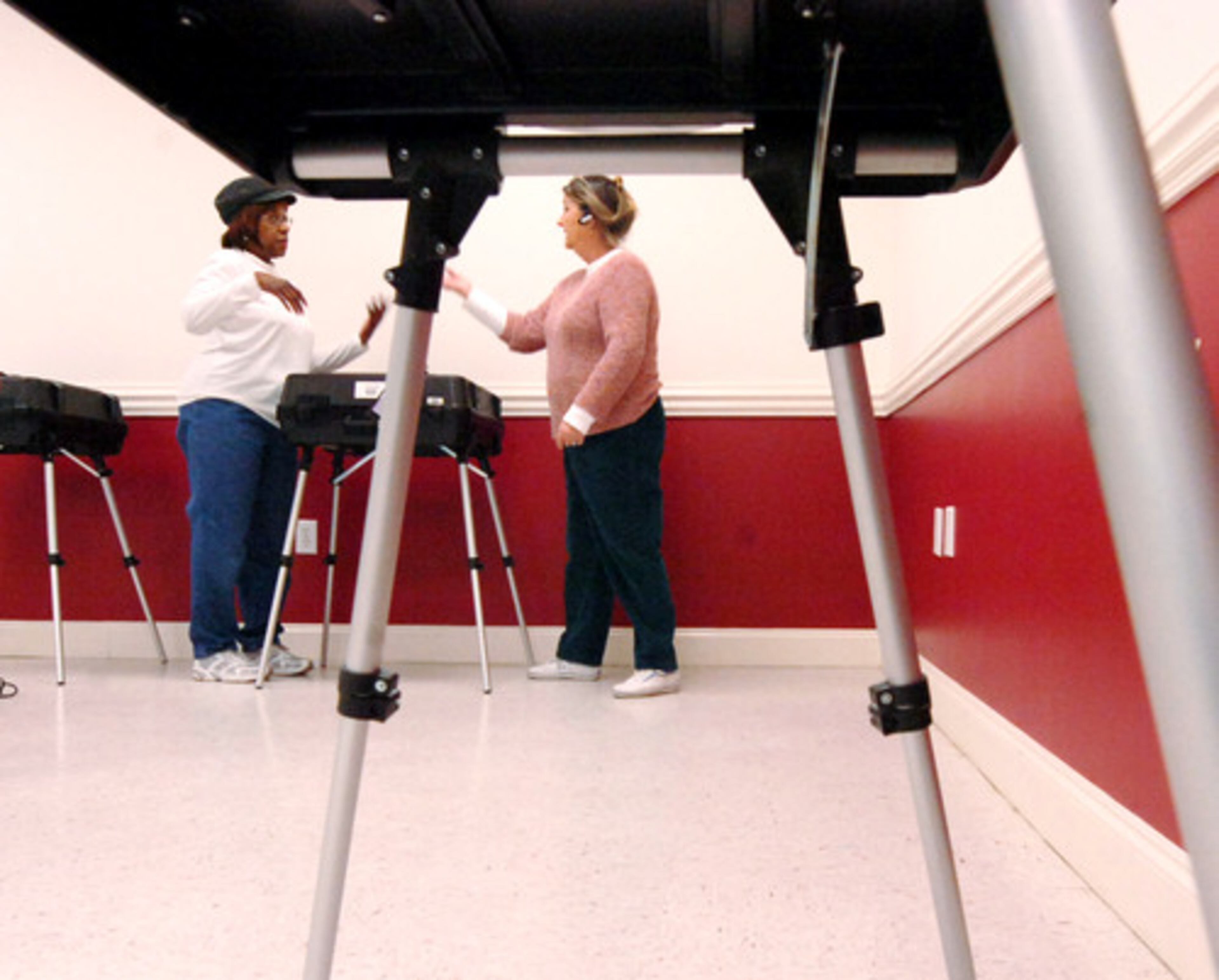 Voting precinct workers Florence Rooker (L) and Marti Miner work together as preparations continue for Tuesday's Georgia primary.