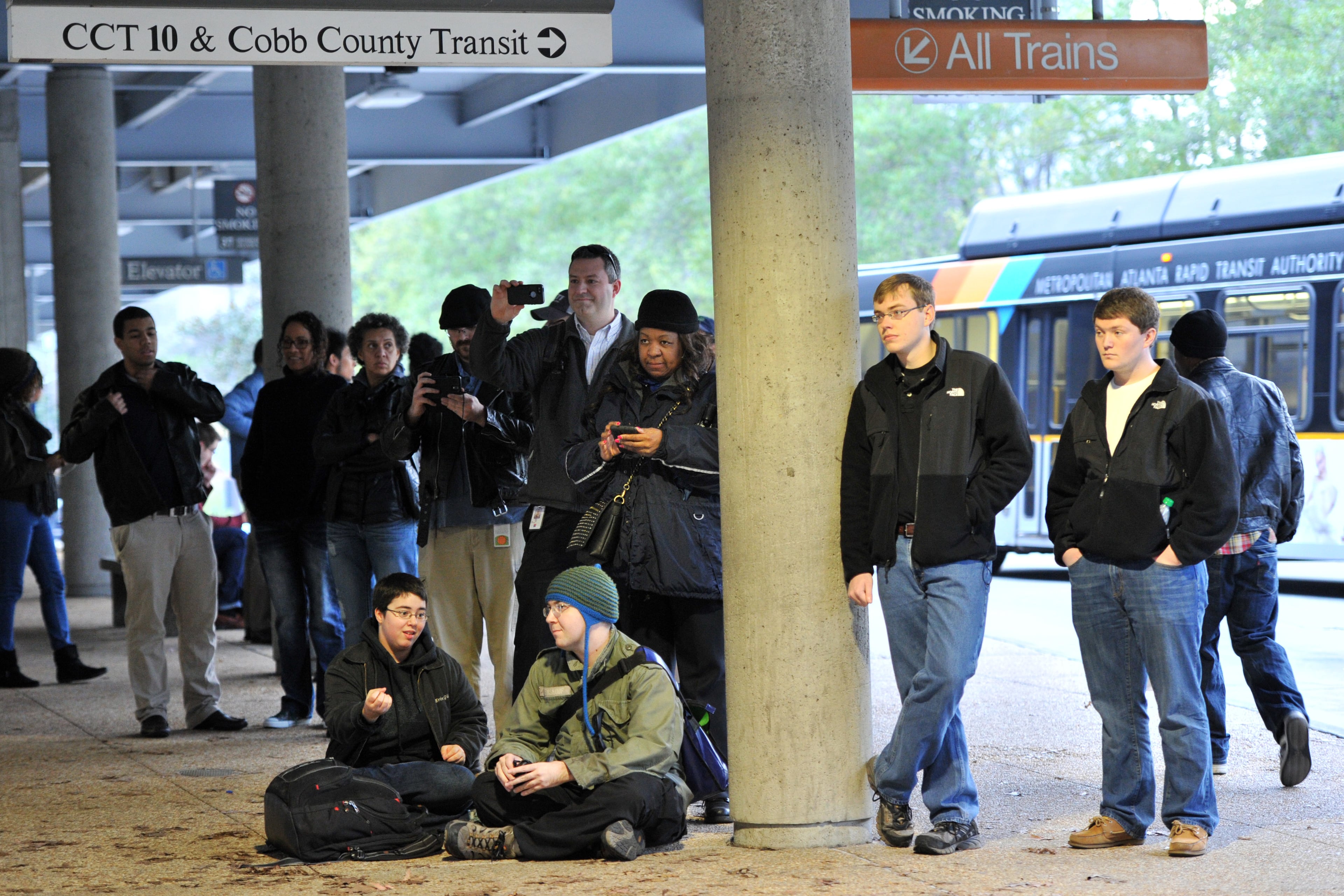 MARTA customers stop and enjoy a free pop-up concert by the Atlanta Symphony Orchestra Brass Quintet at MARTA Arts Center Station on Friday, Dec. 20, 2013.