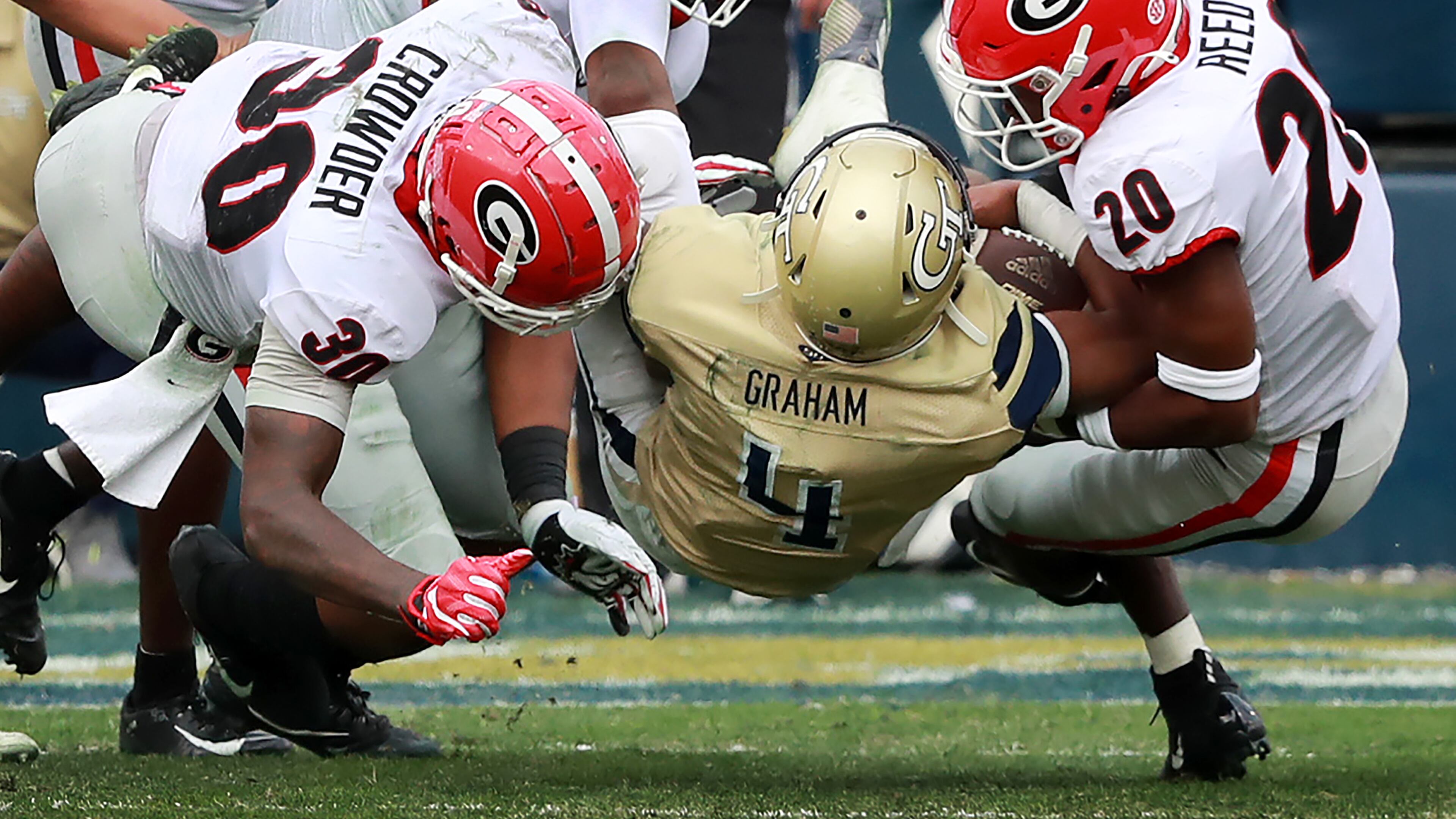 Georgia defenders Tae Crowder (from left), Tyler Clark, and Jr. R. Reed level Georgia Tech quarterback James Graham during the second quarter in a 52-7 Georgia victory during a NCAA college football game on Saturday, November 30, 2019, in Atlanta. Curtis Compton/ccompton@ajc.com